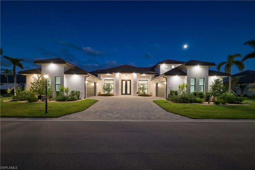 Located within the exclusive double-gated waterfront community of Tarpon Point/Tarpon Estates in Cape Coral, this private enclave of 45 homesites features a custom Tundra Homes residence. Completed in 2024 this home was crafted with exceptional luxury. The home offers 4000+ square feet of living space including four bedrooms and 3.5 baths. A voluminous great room designed for entertaining. 14' tray ceiling, motorized window coverings. Accordion sliders that open seamlessly to the outdoor living area. The gourmet kitchen is well-appointed with high-end GE Monogram stainless steel appliances. Includes a 60” side by side refrigerator/freezer, 36" cooktop, wall oven, air fryer/ microwave combo and dishwasher. The space is enhanced by custom wood cabinetry, large island, quartz countertops, ice maker and butler's pantry. The owner's retreat serves as a private sanctuary with pool access, large soaking tub, walk-through shower and expansive walk-in closet. The second floor boasts a 20’x27’ media/game room with motorized shades, potential for a bar/kitchenette and a balcony with stunning views of the pool and mangroves. This level also includes a guest bedroom and full bath. Attention to detail is evident throughout. 10' double entry doors, coffered ceilings, 8' solid interior doors and plank tile floors. The residence is also equipped with a whole house water filtration system, smart home technology and 3 zone sound system. Car enthusiasts will appreciate the 2 separate oversized 2 car attached garages. The private outdoor oasis includes a covered lanai with shell stone pavers, summer kitchen, outdoor shower, pool bath and heated salt water pool and spa. The home is equipped with impact windows and doors, security system with 12 cameras and generator. Tarpon Point residents enjoy seasonal concerts & events, a full-service marina w/ wet slips for vessels up to 125’, fishing charters, dolphin tours, boat rentals & water taxi to Ft. Myers Beach, stellar restaurants, boutiques, day spa, two pools, hot tub, sauna, fitness center and tennis. Private helipad adjacent to marina. www.tarponpoint.com