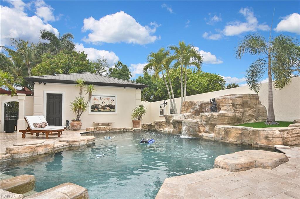 Welcome to an extraordinary custom-built Mediterranean estate in the heart of Fort Myers, just one block from the Caloosahatchee River and ideally situated off the iconic McGregor Boulevard. This private tropical oasis offers over 6,000 square feet of air-conditioned living space—including a separate ground-level guest suite—and more than 12,600 total square feet of exceptional indoor and outdoor living. Meticulously maintained and continuously updated, this residence showcases superior craftsmanship with soaring ceiling heights from 10 to 22 feet, highlighted by custom coffered and tray ceilings throughout and enhanced by elegant indirect lighting and beautifully appointed fixtures. Travertine flooring and rich hardwood floors create a seamless blend of warmth and sophistication. The gourmet kitchen is designed to impress, featuring a Sub-Zero refrigerator, walk-in pantries, wine cooler, and a dedicated bourbon room—perfect for entertaining. A charming reading nook adds character, while expansive living spaces flow effortlessly into a media room and multiple en-suite guest accommodations. The home offers six bedrooms and six bathrooms, including two luxurious primary suites. Step outside into your own resort-style retreat. The custom heated pool is a true work of art, featuring cascading rock waterfalls, a sun ledge, and exquisite marble inlays commissioned from an Australian artist. Surrounded by lush landscaping and complete privacy, the courtyard creates a serene and secluded setting. Motorized screened lanais allow for year-round enjoyment while keeping insects at bay. Additional highlights include:     •    Detached 3-car garage with over 1,000 sq ft air-conditioned space     •    Separate ground-level guest suite for privacy and flexibility     •    Hurricane-impact, energy-efficient glass throughout     •    State-of-the-art security camera system     •    Outdoor kitchen and grilling area     •    Pergola with hammock and multiple covered patios and decks     •    Over 1,000 sq ft front porch living space     •    RV parking with hookup + Tesla charging station     •    Hunter Douglas shades and plantation shutters throughout     •    Spa-inspired primary bath with multiple shower heads and body sprayers This one-of-a-kind estate offers the perfect combination of luxury, privacy, and functionality in one of Fort Myers’ most sought-after locations. Furnishings are negotiable, providing a rare turnkey opportunity. Experience elevated coastal living in a private tropical sanctuary just moments from the river.