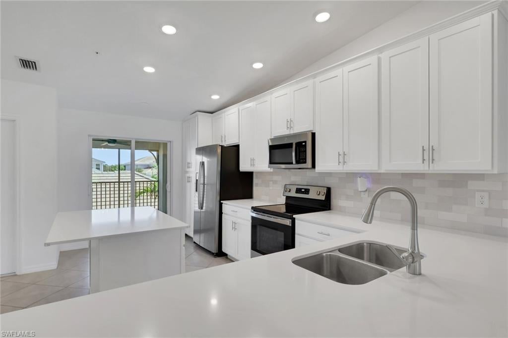 One or more photo(s) has been virtually staged, AI generated or rendered.  BUNDLED GOLF MEMBERSHIP INCLUDED! Discover exceptional value at The National Golf & Country Club with this beautifully enhanced 2-bedroom, 2-bath condo featuring a spacious den, private one-car garage, additional storage, and spectacular southwest-facing lake and championship golf course views. The highly desirable Bromelia II floor plan offers a bright, open-concept design filled with natural light and enhanced by stylish finishes, including a tile backsplash, custom coffee bar, decorative accent wall, and ceiling fans throughout.
The versatile den is ideal for a home office, media room, or additional guest space. Step outside to the screened lanai, where panoramic water and golf course views create an inviting setting for morning coffee, outdoor dining, and colorful Southwest Florida sunsets. Whether you are searching for a full-time residence, seasonal retreat, or investment property, this move-in-ready Ave Maria condo offers an outstanding combination of lifestyle, amenities, and value.
Ownership includes bundled golf privileges at The National Golf & Country Club, featuring a Gordon Lewis-designed championship golf course. Residents also enjoy an impressive collection of resort-style amenities, including a fitness center, resort pool and spa, pickleball, tennis, bocce, gated security, and convenient on-site dining at The Hammock Bar & Grill. Located in the growing master-planned community of Ave Maria, Florida, this golf condo provides the ideal opportunity to enjoy an active, amenity-rich lifestyle surrounded by beautiful scenery. Schedule your private showing and experience one of the best bundled-golf condo opportunities currently available in Ave Maria!