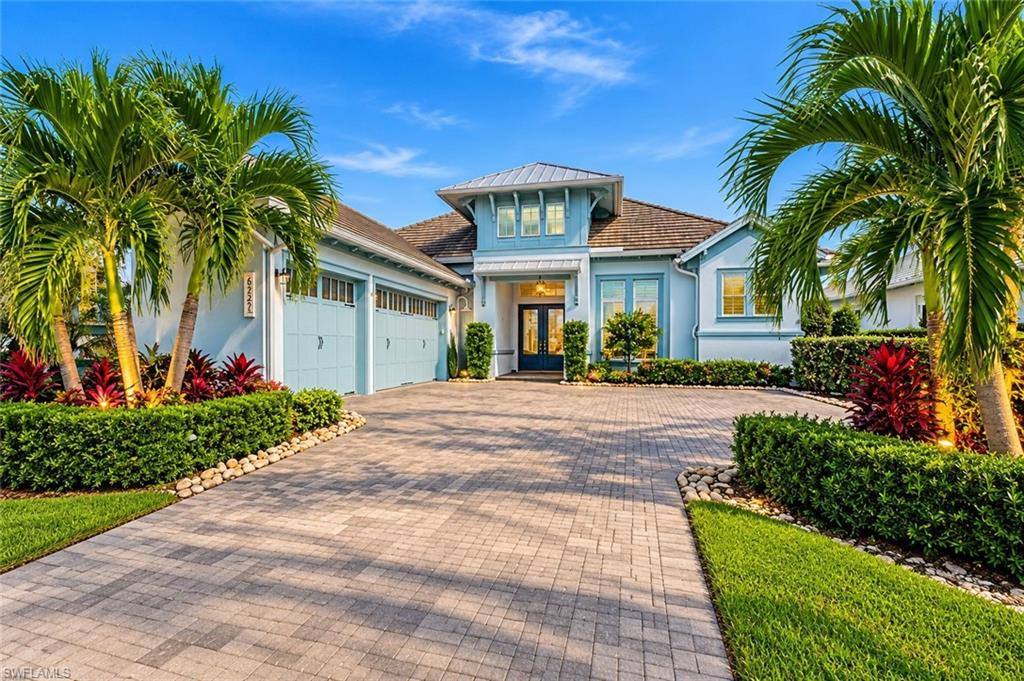 SPECTACULAR STOCK-BUILT MADISON II | 4 BEDROOMS + DEN | 5 BATHROOMS | AN OUTDOOR ENTERTAINER'S DREAM! Built in 2022 by renowned STOCK CONSTRUCTION, this exceptional residence showcases the highly sought-after MADISON II floor plan, extraordinary custom upgrades and BREATHTAKING WATER VIEWS. Rich HARDWOOD FLOORS with inlaid marble accents, CUSTOM WOOD CEILING BEAMS, plantation shutters, designer lighting and LUTRON DIMMERS create an atmosphere of coastal elegance. The great room features a stunning STACKED-STONE ACCENT WALL and illuminated shelving, while expansive CORNER SLIDING GLASS DOORS seamlessly connect indoor and outdoor living. The GOURMET KITCHEN boasts premium, appliances, custom cabinetry, decorative glass tile and enhanced island storage. The luxurious PRIMARY SUITE offers custom closets and a SPA-INSPIRED BATH with rainfall shower, body jets, premium tile and TOTO wash systems. ALL BEDROOMS FEATURE ENSUITE BATHROOMS, offering comfort and privacy for family and guests alike. The OUTDOOR LIVING SPACE is truly the showstopper! An expansive covered lanai features CUSTOM WOOD BEAMS, DESIGNER WOOD PLANK ACCENT WALL, CUSTOM WRAP AROUND CABINETRY, PANORAMIC PICTURE WINDOW SCREEN ENCLOSURE, architectural privacy walls, designer lighting and TWO-ZONED OUTDOOR AUDIO. The SPECTACULAR OUTDOOR KITCHEN includes a built-in WEBER GRILL, side burner, refrigerator, CLEAR-ICE MAKER, sink and custom wrap around cabinetry. Enjoy the HEATED SALTWATER POOL & SPA with SUN SHELF and dramatic FIRE FEATURES, surrounded by lush tropical landscaping, mature palms, PANORAMIC WATER VIEWS and NO SEE-UM SCREENS. Additional upgrades include a KOHLER WHOLE-HOME GENERATOR, 1000 GALLON PROPANE TANK, IMPACT WINDOWS AND DOORS and INTEGRATED METAL STORM SCREENS on Patio. The expansive THREE- CAR GARAGE is beautifully appointed with CUSTOM CABINETRY, offering exceptional storage and ample space for vehicles, recreational equipment, and all the essentials of an elevated Florida lifestyle.  Two A/C systems, WATER FILTRATION, softening and reverse osmosis, CUSTOM LANDSCAPING including rare GREEN QUARTZITE Stone with lighting and an EXPANDED PAVER DRIVEWAY. HOME IS BEING SOLD PARTIALLY FURNISHED. Located in the 2,400-acre ISLES OF COLLIER PRESERVE, offering scenic trails, kayaking, RESORT & LAP POOLS, fitness center, 14 PICKLEBALL COURTS, tennis, bocce and the OVERLOOK BAR & GRILL. Approximately 7 MINUTES TO DOWNTOWN NAPLES, FIFTH AVENUE SOUTH and minutes to BEAUTIFUL GULF BEACHES. EXPERIENCE THE ULTIMATE NAPLES LUXURY LIFESTYLE!