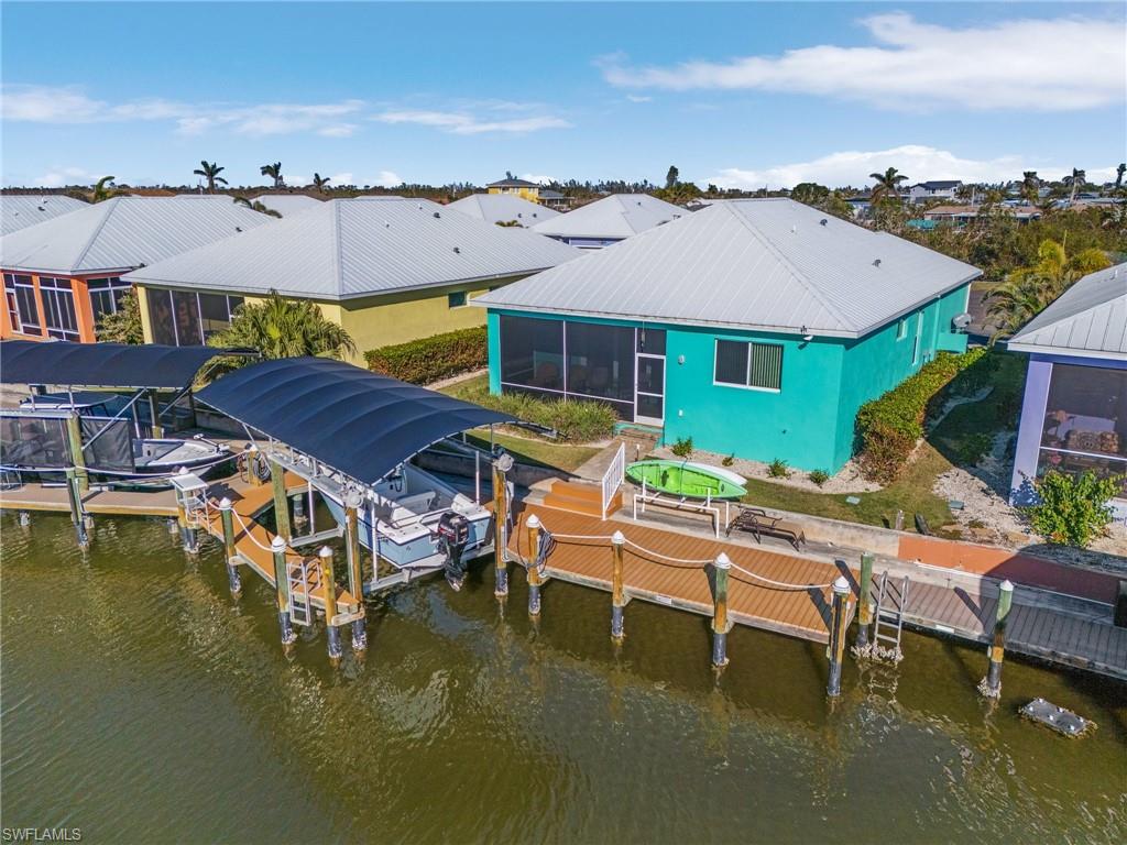 Highly desirable direct access waterfront home in sought-after Treasure Cove! Enjoy serene canal and preserve views, this like-new 3-bedroom, 2-bath property offers everything you need to enjoy the island lifestyle. Built with durable concrete block construction, it features a metal roof, impact windows and doors, soaring 10’ ceilings, and elegant 8’ doors. The interior is just as impressive, with granite countertops, beautiful wood cabinetry, and modern finishes throughout. Outside, enjoy a paver driveway, a screened lanai, and unparalleled access to some of Florida's best boating and fishing. With deep water access and no bridges to navigate, this home is perfect for water enthusiasts. Fish and boat from your backyard. Enjoy your own private dock and boat lift. Welcome to the Island!
