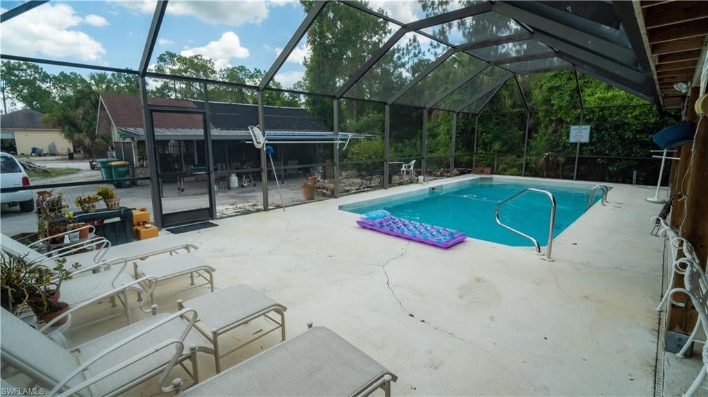 This is not your typical single-family pool home. This property offers endless opportunities for the right family! The main house features a brand new roof, newly installed tile throughout except in 2 smaller bedrooms, hurricane impact windows and doors, new water heater, new reverse osmosis system, all new interior doors, freshly painted interior, pool resurfaced and an amazing extended lanai. As you step outside your super screened-in pool, you'll encounter a fully enclosed ranch-style commercial kitchen equipped with everything you need to start a catering business or simply entertain your guests! 8 burner gas stove, double oven, Sub-Zero freezer, extra fridge, pots and pans all ready for you to dive into your culinary creations! But, that's not all...as you approach the back of the property, you have a 1900 sq ft concrete shop. You can also make it as a new business, such as a dance studio, salon or any creative business ideas... the possibilities are endless! It also has a dual access garage complete with its own electrical junction box, permitted through county and installed by FPL. This space offers ideal conditions for a business or fun playground... you decide, possibilities are endless! As an extra bonus, the property also has a 200 sq-ft storage shed and is extra outdoor bathroom! Not to mention the delicious fruit trees you'll get to enjoy, mango, papaya, avocado... can it get better?!? No flood insurance!! Schedule your showing today!