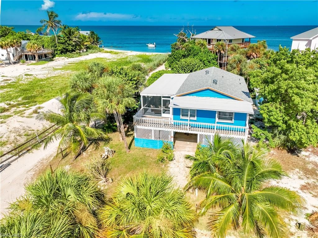 Almost Beachfront!  Don't miss this cute beach cottage just steps to the beach with incredible views from the front porch.  Sit back, relax, and enjoy the Gulf  & Sunset, surrounded by the sounds of the surf, with the expansive grass airfield as a wonderful buffer from other homes. A perfect spot for your dream retreat this close to the beach. Start your mornings with a walk along the shoreline, spend the afternoon swimming and shelling, and return home to enjoy it all from the shady front porch. Upstairs features panoramic Gulf & Airstrip Views, plus two bedrooms & one bath, with a cozy living space. On the ground level, another bonus sleeping room and bath are great for extra guests. For aviation enthusiasts, the setting is especially unique: the property directly borders North Captiva's private grass airstrip, creating the possibility of turning the journey to your island home into part of the adventure.
North Captiva is a boat-access-only barrier island known for miles of beautiful beaches, protected preserve lands, abundant wildlife, and its relaxed golf-cart lifestyle. Whether you're looking for a personal beach escape, vacation property, or a special North Captiva home with an aviation connection, this property offers a combination of beach proximity, Gulf views, privacy, and location that's difficult to duplicate at this price point.