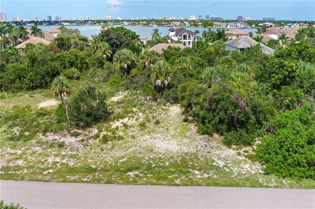 Welcome to prestigious Estates area of Marco Island, where privacy, luxury and natural beauty come together. This oversized half-acre homesite provides the ideal foundation to create the coastal residence of your dreams. With its western exposure and high elevation, the property offers the possibility of stunning views of Roberts Bay and Barfield Bay from your future custom-built home. Imagine relaxing on your lanai while enjoying breathtaking sunsets and tranquil surroundings of one of Marco Island’s sought-after neighborhoods. The Estates is renowned for its spacious lots, peaceful ambiance and impressive luxury residences, providing a sense of exclusivity while being close to everything Marco Island has to offer. From this prime location, you are just minutes from pristine beaches, waterfront dining, boutique shopping, schools and countless recreational opportunities. Whether you envision a contemporary coastal retreat, a classic Mediterranean-style estate, or a modern masterpiece, this homesite offers the space and setting to bring your vision to life. Do not miss the opportunity to secure one of the finest available properties in the Estates of Marco Island. With its exceptional location, expansive size, and potential for incredible water views, this property represents a place to create your ultimate island sanctuary.