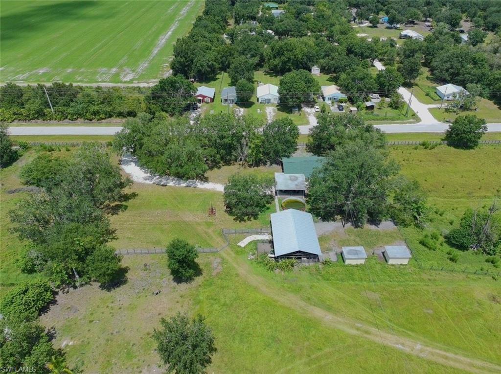Discover this exceptional 10-acre residential and agricultural estate, offering endless possibilities for farming, livestock, or a peaceful country lifestyle. The property features a well-maintained four-bedroom, two-bathroom home with spacious closets in every bedroom and a two-car carport. Designed for productivity, the farm includes three storage sheds, a barn with a dedicated feed room, a3,000 square foot metal building equipped for swine production, a separate metal building designed for poultry operations, and an open-sided metal barn, ideal for horses or equipment storage. Additional improvements include a2,000 square foot concrete block building and a 4,000 square foot metal building, providing ample space for agricultural, commercial, or storage use. A scenic pond supplies water for livestock while enhancing the property’s natural beauty. This unique property is move-in ready and perfectly suited for both residential living and agricultural operations, making it a rare opportunity for buyers seeking space, functionality, and long-term value.