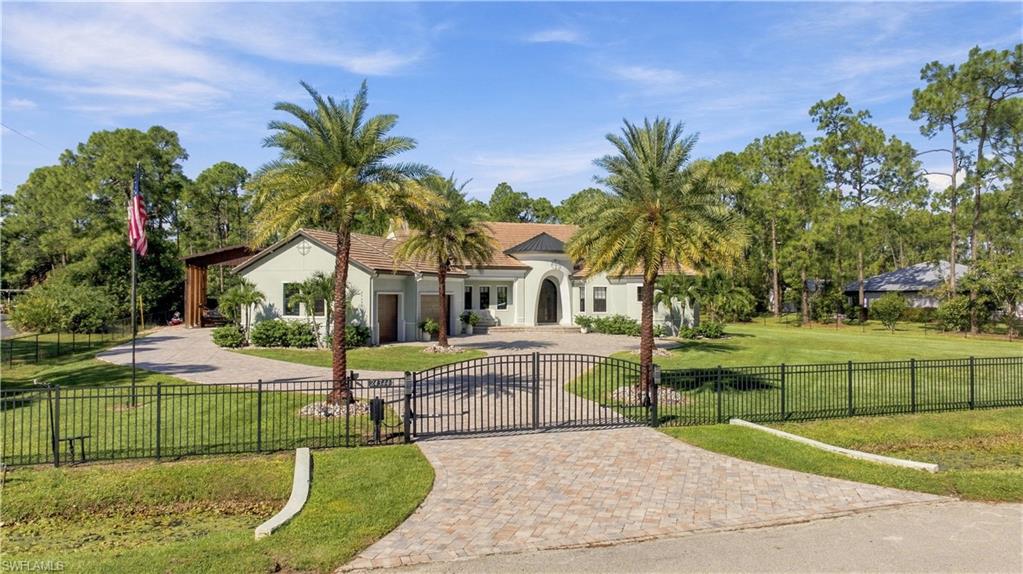 PRIVATE 1.25-ACRE BONITA SPRINGS ESTATE/RESORT POOL/1,000-SQ-FT ENGINEERED RV/TOY BARN/NO HOA
Luxury Acreage Living w/ Resort Amenities & Exceptional Storage Located in desirable San Carlos Estates. This fully fenced & gated 1.25 Acre private estate delivers custom luxury resort style outdoor living and rare large scale storage-All with No HOA. Built in 2020, the approx. 2740 sq ft custom residence features 3 bedrooms plus Den, 3 full baths, 12 ft ceilings, hurricane impact windows & door, A 10 ft Cantera Art Deco entry door and 10 ft zero edge sliding glass doors that fully open to the outdoor living area. The open concept design centers on a chefs kitchen with custom cabinetry, oversized island, walk-in pantry & custom bar w/ wine cooler. The great room & dining area are designed for seamless entertaining with direct pool & lanai access Resort-Style Outdoor Living. The outdoor space is a true private resort anchored by a 30,000 gallon heated saltwater pool & spa with tanning shelf, bubblers & illuminated glass bowl water features. Additional features include a 10 person spa, outdoor kitchen with gas grill, custom fireplace and 24'x12' Gazebo creating a complete year-round entertainment environment. The primary suite offers a private retreat with a spa-style bath featuring a walk-through multi-head shower, freestanding soaking tub, dual vanities & a private water closet. Custom walk-in closet includes dedicated shoe storages. RARE Engineered RV/Toy Barn standout feature is 25'x 40' high. Engineered outbuilding offering approx. 1000 sq ft of covered space with an 80-amp service and RV hookup. Purpose-built for versatility, accommodates an RV, Boat, Collector vehicles, motorcycle workshop use or secure storage. The 16 ft height & expansive footprint make this a rare luxury estate amenity in Bonita Springs. Wide paved access allowed easy maneuvering of large vehicles & equipment. Privacy, Security & Location. This Estate is fully fenced & gated with powered entry gates, mature landscaping, irrigation & security lighting for complete privacy. Three-car attached garage  adds additional parking & includes a dedicated gym space. Situated in San Carlos Estates, the property offers 1.25 Acre living with NO HOA & NO FLOOD INS required while remaining minutes from beaches, dining & shopping. Located approx. 6 miles from Bonita Beach, it delivers both seclusion & convenience. 
The Life Style: A private Southwest Florida estate offering luxury interiors, resort-style outdoor living and unmatched storage flexibility-All on 1.25 acres just minutes from the Gulf.  A rare opportunity to own a Turnkey estate combining Privacy, Scale & Versatility in one of Bonita Springs most sought after acreage communities.
