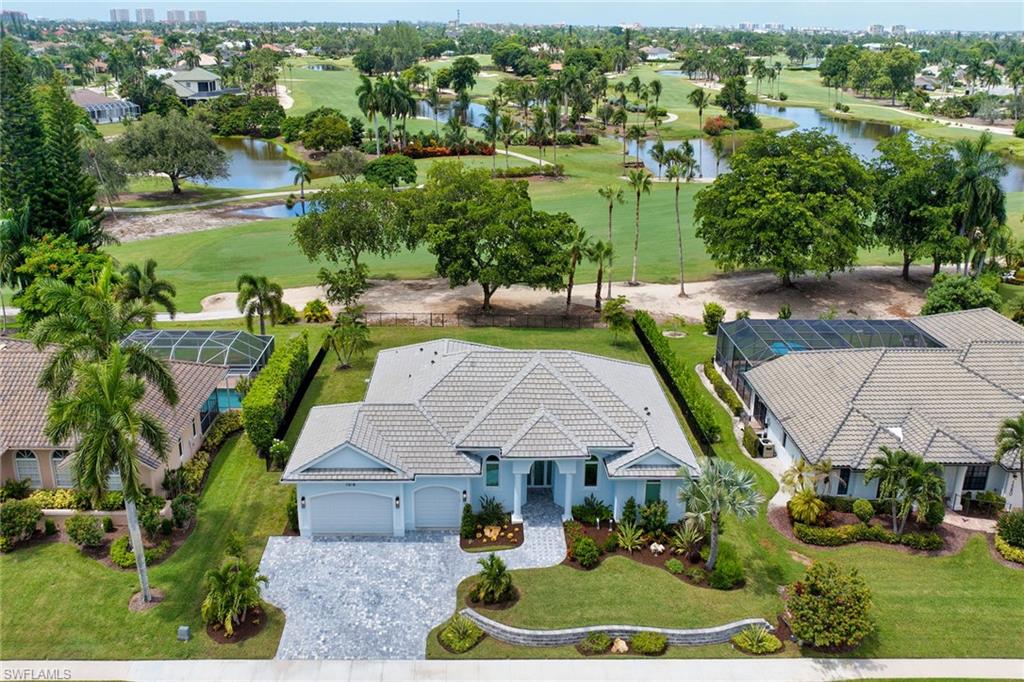 Along the 16th fairway of Marco Island’s prestigious Island Country Club, this beautifully updated pool residence showcases panoramic golf course, pond and fairway views with desirable northwestern exposure. Offering four bedrooms, including a flexible office, 2.5 baths and an air-conditioned three-car garage, the home pairs an exceptional setting with sophisticated interiors and impressive outdoor living. Hardwood flooring throughout, predominantly 10-foot ceilings, eight-foot solid-wood doors and Level 5 finishes create a refined atmosphere, while the great room captures sweeping water and fairway views through expansive glass sliders and features a vaulted ceiling with LED lighting, a millwork accent wall and statement chandelier. Designed for entertaining, the kitchen features EJH custom soft-close cabinetry, an oversized island, Pompeii quartzite counters, a custom marble backsplash, under-cabinet lighting and a Kohler apron-front sink. Premium appliances include a 42-inch Sub-Zero French-door refrigerator, a Wolf six-burner dual-fuel range, a hood and warming drawer, a Sharp microwave drawer, Fisher & Paykel dishwasher drawers, and a Zephyr beverage refrigerator. Set on an oversized 100-by-150-foot lot with a fully fenced yard, the residence was completely redesigned and rebuilt inside to meet 2025 standards, featuring impact-resistant windows and doors, tied-down rafters and walls, spray-foam roof insulation, new PEX plumbing, new wiring and insulated interior walls for sound reduction. The primary suite enjoys a panoramic lanai, water and fairway views, remote-controlled room-darkening shades and an oversized custom walk-in closet. Its luxurious bath offers an oversized tiled shower with rain, handheld and standard shower options, polished-nickel fixtures, dual custom vanities with quartzite counters, an anti-fog LED mirror and a separate water closet with a Toto Washlet. A guest suite features a private bath, custom closet and motorized SPF and room-darkening shades, while another guest room and flexible fourth bedroom or office provide versatility. The laundry room combines custom cabinetry and quartzite counters with a Chicago-brick herringbone floor, and GE washer and dryer. Outdoor living centers around the covered lanai with a composite slat ceiling, television, slip-resistant ceramic tile and remote-controlled impact Kevlar screens. The heated gunite pool was completely refurbished in 2026 with new mechanical equipment, a glass tile border and tile decking. Additional features include a Generac gas generator, a 500-gallon underground propane tank, three-zone HVAC, a Kinetico water softener, a 2026 Rain Bird irrigation system and a three-car garage with mini-split air conditioning and additional storage. Just minutes from Marco Island’s pristine beaches, dining, shopping, golf and recreation, this home offers an exceptional blend of coastal luxury and active island living, with the executive airport nearby for convenient travel.