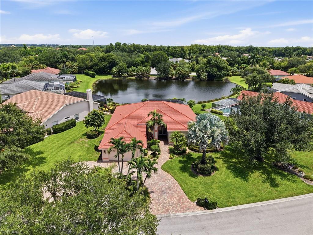 Welcome to this elegant home set on a beautifully landscaped .37 acre lakefront lot in the sought after, gated community of Cedar Creek. Being sold partially furnished, this spacious 4 bedroom, 4 bath home offers 2,715 sq ft of living space, with soaring archways, elegant French doors, and a bright, split bedroom layout throughout.

The kitchen features granite countertops, and a full suite of appliances, all flowing seamlessly into the family and dining areas for effortless everyday living and entertaining. All appliances, window treatments, and fixtures convey with the sale. Rich wood flooring and tasteful architectural details carry throughout the main living spaces, adding warmth and character. 

The primary suite offers a true retreat with dual sinks, a separate soaking tub and shower, and a generous walk in closet, while the additional bedrooms provide comfortable, flexible space for family, guests, or a home office.

Step outside to a updated screened lanai overlooking the lake, complete with a heated pool and spa, perfect for relaxing or entertaining against a peaceful water backdrop that feels so so private.

Cedar Creek offers residents access to a clubhouse, community pool, pickleball, tennis courts,  kayak/canoe launch with "gulf" access and a play area, all within a beautifully maintained, gated setting close to Bonita Springs' shopping, dining, and beaches. One of the best features......low HOA fees of $700 per quarter. 

From the tranquil lake views and circle drive to the inviting outdoor living space, this home is ready to welcome you in. All the main systems have been replaced including the roof and air conditioning along with impact windows or roll-down shutters for peace of mind during storm season. Come see for yourself why this home and Cedar Creek is one of the best options in Bonita Springs.