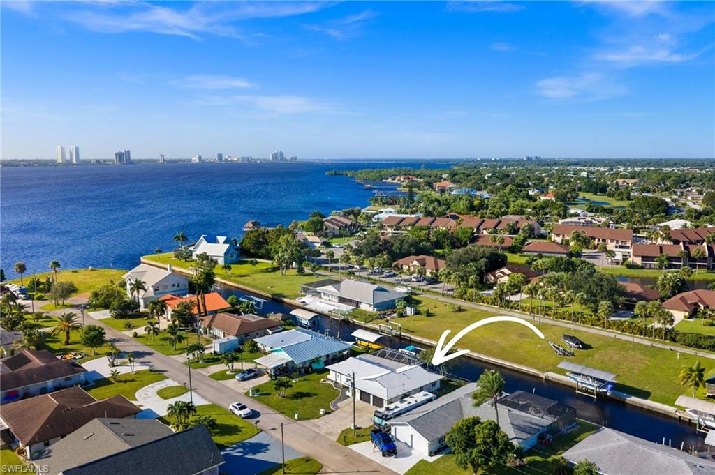 DIRECT GULF-ACCESS pool home in North Fort Myers! Completely remodeled in 2024 and offered FURNISHED, this beautifully updated waterfront residence features 3 bedrooms, 2 bathrooms, nearly 1,500 sq ft of living space, and a 2-car garage. With stylish finishes, extensive upgrades, and a versatile floor plan, the home is ideally suited for a full-time residence, seasonal getaway, or income-producing rental property. Luxury vinyl plank flooring extends throughout the main living areas and bedrooms, while the beautifully updated kitchen features a quartz waterfall island, white shaker cabinetry, stainless-steel appliances, and a convenient pass-through window to the lanai. An adjoining dining area provides plenty of space for gathering. The primary suite offers direct lanai access through French doors, a walk-in closet with built-ins, and an en-suite bathroom. Designed to embrace the Southwest Florida waterfront lifestyle, the expansive outdoor living area features a spacious pool deck with travertine pavers, a picture-frame screened lanai and generous covered and open-air spaces for poolside dining, entertaining, and soaking up the sun. A private dock with boat lift offers exceptional boating convenience, with a short, direct canal route leading to the open waters of the Caloosahatchee River in just minutes. A separately fenced portion of the yard also provides an ideal outdoor play area or space for pets. Additional highlights include impact-resistant windows for enhanced storm protection, as well as a metal roof. The property also presents an attractive investment opportunity, with a proven rental history and reservations already secured for late 2026 and into 2027, offering an established income stream and continued rental potential. Ideally situated in North Fort Myers, the home is just a short drive from the Downtown Fort Myers River District, offering an exciting collection of waterfront restaurants, shopping, galleries, and entertainment. Whether enjoying a day on the boat, relaxing poolside, or exploring the nearby River District, this waterfront retreat captures the best of Southwest Florida living.