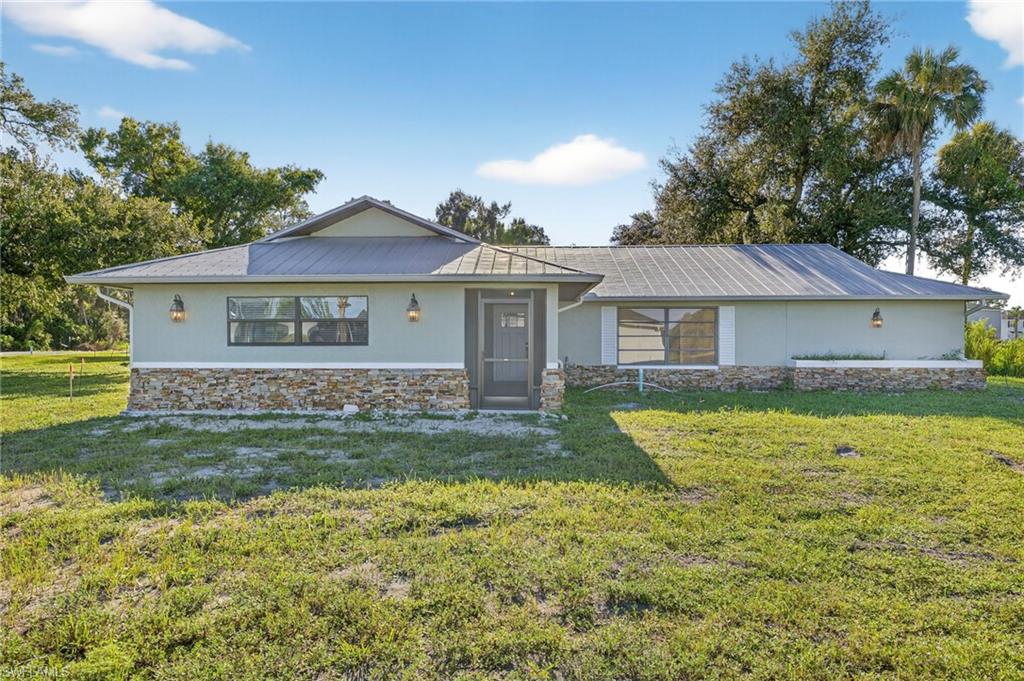 Nestled within the newly developed Bayshore Ranch community, this exceptional property stands apart as a rare original, existing prior to Lennar’s acquisition and development of the area. Situated on just over an acre, it offers privacy, space, and character not found elsewhere in the neighborhood.

The home features a durable metal roof and tile flooring throughout, combining longevity with low maintenance. A spacious great room with vaulted ceilings and elegant crown molding creates an ideal setting for entertaining. The kitchen is thoughtfully designed with granite countertops, a central island, and ample cabinetry.

Additional highlights include a large detached garage with a lean-to roofed structure—perfect for storage, hobbies, or additional parking, as well as a freshly painted interior and a well-appointed laundry room complete with cabinets and a utility sink.
This is a rare opportunity to own a distinctive property with acreage and custom features inside a modern community setting.