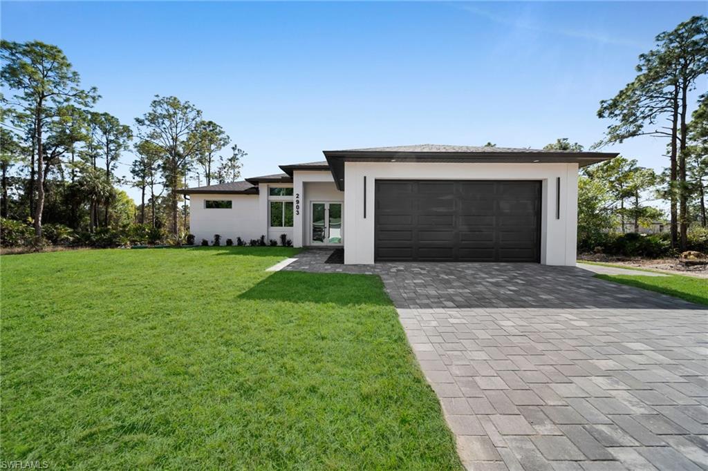 Brand-new construction offering 1,507 sq ft under air with a thoughtfully designed 3-bedroom, 2-bath floor plan plus an additional half bath conveniently located for a future pool. This modern home features an open-concept layout with high ceilings, oversized tile flooring throughout, and abundant natural light. The contemporary kitchen boasts quartz countertops, custom cabinetry with designer hardware, stainless steel appliances, and a spacious island ideal for entertaining. Impact windows and doors, sleek lighting fixtures, and quality finishes elevate the home’s modern aesthetic. The primary suite offers a spa-inspired bathroom with a glass-enclosed shower and stylish finishes. Enjoy a covered lanai overlooking a large backyard with plenty of room to add a pool. No HOA, no CDD, and located in a growing area with new construction surrounding—perfect for a primary residence or investment opportunity.