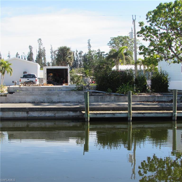 Pine Island Cove ... Canal front vacant lot ready to build...55+ community, pool, boat-ramp, tennis, pickleball, Clubhouse, picnic area, dog run, fish cleaning station, bocce,... sewer/water and great neighbors. Modular/manufactured community. Canal frontage bring your boat !!! There is a boat lift at end of canal... lift your boat over the embankment to a direct access canal to Pine Island sound. Convenient location for boating and fishing to the Pine Island Sound, Gulf of Mexico, Ft Myers Beach, Sanibel, Captiva, Cayo Costa or Boca Grande. All within a 20 minute boat ride.