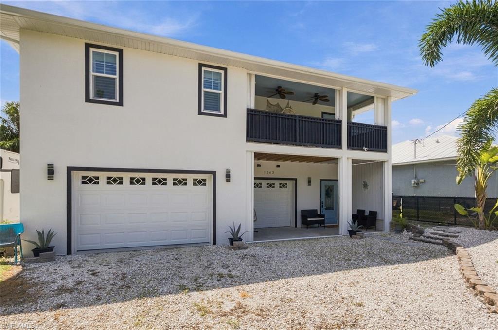 RARE DOUBLE-LOT OPPORTUNITY IN BOKEELIA! Built for durability, designed for island living, and offering exceptional space for your boats, RVs, and recreational toys! This custom-built home at 7263 Hibiscus Avenue stands apart with its impressive 6-inch-thick insulated concrete form (ICF) walls, metal roof, impact-resistant windows and doors, and additional exterior hurricane shutters, providing exceptional storm protection and energy efficiency. Situated on an expansive DOUBLE LOT, this property offers the space, privacy, and flexibility that's increasingly hard to find. The three-car garage, air-conditioned garage space, fenced yard, and convenient 30/50-amp RV hookups make this an ideal property for boating enthusiasts, RV owners, and those who appreciate room for their hobbies and outdoor lifestyle. Inside, quality craftsmanship continues with soaring cathedral ceilings, porcelain tile flooring, granite countertops, hardwood cabinet doors, solid-core interior doors, and beautifully finished custom tile showers. A fully transferable A/C maintenance contract with professional service twice annually provides additional peace of mind. LOCATION IS ANOTHER HIGHLIGHT! Situated approximately half a mile from Pineland Marina and the popular Tarpon Lodge, you're just a short golf-cart ride from boating access, waterfront dining, and the laid-back charm of Pine Island. Enjoy the convenience of nearby marina access without the expense or maintenance associated with owning waterfront property. Whether you're searching for a durable island retreat, a home with room for your recreational vehicles, or a property offering quality construction and extra land, this unique Bokeelia home delivers a combination of features that's difficult to replicate!