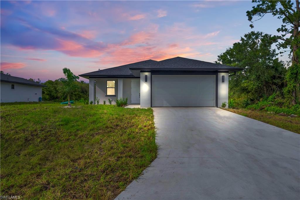 *Builder offering up to $10,000 towards buyers’ closing costs*Builder offering special financing incentives through preferred lender for qualified buyers, potentially including interest rate buy-downs, reduced lender fees, and other favorable terms. Terms, conditions, and qualification criteria apply. Looking for more space without breaking the budget? This brand-new construction built by Envision Construction delivers incredible value with 3 generously sized bedrooms, 2 full bathrooms, and a thoughtfully designed open-concept layout that balances comfort, style, and affordability.The heart of the home is the modern kitchen, complete with a large center island, sleek cabinetry, and plenty of counter space—perfect for meal prep, entertaining, or gathering with family and friends. Open living and dining areas flow seamlessly together, creating a bright, inviting atmosphere. Step outside and enjoy a spacious backyard that’s ideal for pets, play, or weekend BBQs. Whether you’re dreaming of a garden, outdoor fun, or a private retreat, the possibilities are endless. Located just off Sunshine Blvd N and minutes from Lee Blvd, you’ll enjoy quick access to shopping, dining, schools, and major roadways—while still savoring peace and privacy at home. Affordable, spacious, and move-in ready—this home is a must-see in Lehigh Acres’ growing community. Schedule your showing today! *outside photos from similar model, inside photos from property*