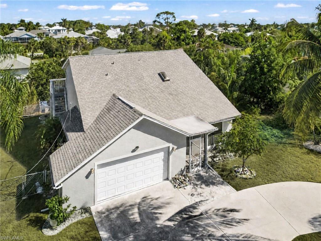 One or more photo(s) has been virtually staged, AI generated or rendered.  **WHAT IF IT WERE YOU? — Your Florida Waterfront Lifestyle Awaits!**

What if your Florida home offered more than just a place to live? Imagine starting your day on the water, exploring the canal by kayak or boat, and following the waterway toward the Imperial River and the Gulf of Mexico. At 27099 Holly Lane, the possibilities are waiting for you!

Beautifully updated and open, this Bonita Springs home offers 3 bedrooms, 3 full baths, and more than 2,000 square feet on a generous 0.34-acre lot with **NO HOA**. A separate living room and family room provide extra space to entertain, relax, and gather with loved ones—a welcome feature for those who appreciate room to spread out.

Beyond the three bedrooms, a main-level flex room currently set up for sleeping and an upstairs loft with a closet and pullout double bed offer additional space for family and overnight guests. Whether you're seeking a year-round residence, seasonal retreat, or second-home investment, this property offers plenty of possibilities. Bonita Springs' seasonal rental market offers an additional opportunity for investors to explore.

Enjoy indoor-outdoor living with a large screened lanai featuring ceiling fans, an expansive canal-side deck with lighting for evening enjoyment, and an upstairs deck connecting all three bedrooms.

The updated kitchen features a large center island. Recent improvements include the kitchen, new flooring in the living and dining rooms, and new stucco. Central air conditioning and an oversized garage with a mini workshop add to the appeal.

The fully fenced yard features a wonderful variety of fruit trees and flowering bushes that create a breathtaking tropical backdrop when in bloom. The generous lot offers room to explore the possibility of adding a pool. A large circular driveway provides abundant parking for multiple vehicles and guests.

The home's naturally shaded setting offers a comfortable retreat from the Florida sunshine after a day outdoors.

Boating enthusiasts will appreciate the canal's connection to the Imperial River, providing a water route toward the Gulf of Mexico. Manatees and dolphins have been spotted in the canal, adding to the magic of Southwest Florida waterfront living.

Conveniently located near Downtown Bonita Springs, enjoy local dining, shopping, arts, festivals, live music, parks, and other Southwest Florida attractions.

**What if this were the Florida home you've been waiting for? Come explore the possibilities at 27099 Holly Lane!**