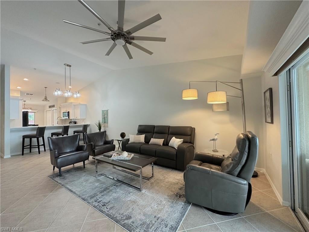 One or more photo(s) has been virtually staged, AI generated or rendered.  Discover the Naples golf and country club lifestyle in this beautifully located 2-bedroom plus den (or optional 3rd bedroom), 2-bathroom condo with 1 car garage in the gated Cypress Trace neighborhood of Cypress Woods Golf & Country Club. Entire unit repainted in 2024. AC 2016, Water heater 2016, Dryer Feb 2024. New smoke detectors. Black stainless steel appliances, Microwave Oct 2024. Granite countertops and beautiful backsplash and built-in dry bar. This spacious second-floor residence features a desirable split-bedroom floor plan, offering a comfortable and versatile layout. The primary suite includes two walk-in closets and an en-suite bathroom with dual sinks and a walk-in shower. Relax on the private screened balcony while enjoying serene lake and golf course views. Wake up to beautiful lakefront sunrises from your rear balcony and end each day with breathtaking sunset views from the front lanai. Enjoy the best of both worlds with stunning waterfront scenery and the perfect setting to relax, unwind, and embrace the Florida lifestyle. Residents enjoy access to three private neighborhood pools and the exceptional bundled golf and resort-style amenities of Cypress Woods Golf & Country Club. Golf enthusiasts can look forward to the Gordon Lewis-designed 18-hole championship course, complete with a driving range and putting green, currently undergoing renovations and scheduled to reopen January 1, 2027. Additional amenities include a fitness center with updated equipment and Peloton bikes, a resort-style pool and spa, lap pool, eight pickleball courts, tennis courts, bocce courts and pavilion, jogging paths, indoor and outdoor dining, a grille room and formal dining, and a full calendar of social activities. Conveniently located east of I-75, this condo offers easy access to shopping, dining, everyday conveniences, and the beautiful white-sand beaches of the Gulf. Experience the best of Southwest Florida living with golf, recreation, relaxation, and an outstanding community lifestyle all in one location!