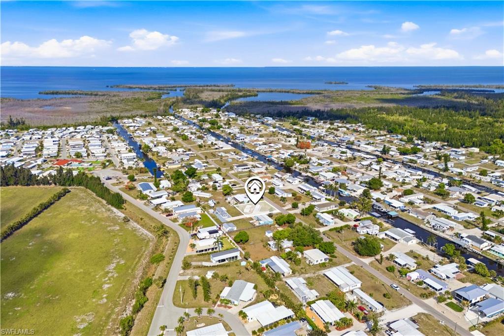 Cleared and improved lot in the desirable Flamingo Bay community offers the ultimate flexibility for your Florida retreat. This slice of paradise is the perfect place to call home, whether you're looking to set up a manufactured home, or build a custom single-family residence. The property comes with city water, electric, and a septic system already in place, significantly streamlining your setup process. Driveway includes a shared access easement. Residents can also take advantage of the voluntary HOA (one-time $500 fee and $325 annual per person), which provides amenities including a boat ramp with Gulf access, a sparkling community pool, clubhouse activities, shuffleboard, and horseshoe pits. Don't miss this affordable opportunity to secure a cleared homesite with access to world-class boating and a vibrant social lifestyle.