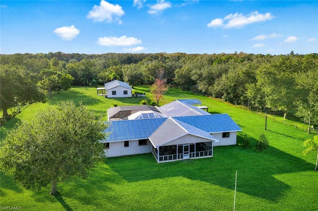 Looking for generational living?  This is it!  Endless possibilities await on this rare 2.5-acre AG-2 zoned property in North Fort Myers! Fully fenced with a gated entrance, this unique estate offers two separate homes—ideal for multi-generational living, rental income, a home-based business, or equestrian use.
The main residence features 4 bedrooms, 3 bathrooms, a screened-in pool with a party-worthy deck and lanai, new appliances, and a 3-car garage with workshop area. The thoughtfully designed layout includes a private 4th bedroom and 3rd bath suite with its own separation—perfect as an in-law suite, teen retreat, guest quarters, or potential income opportunity.
Located toward the rear of the property is a second home offering 2 bedrooms, 1 bathroom, a screened porch, and a 1½-car garage, providing excellent flexibility for extended family, visitors, or rental use.
With AG-2 zoning, there is ample room for horses, gardens, workshops, or business equipment, all while enjoying the privacy and space of acreage living—yet still conveniently located near shopping, dining, and major roadways.
Whether you’re looking for generational living, income potential, or space to live and work, this versatile property delivers a truly rare opportunity in North Fort Myers.
