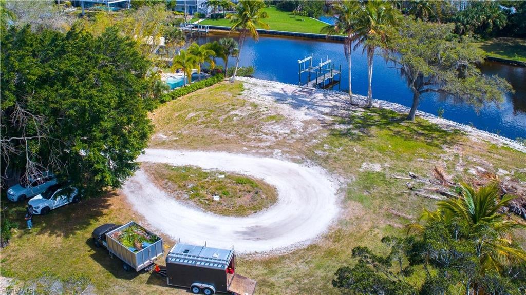 Excellent riverfront lot on the Imperial River with direct access to the Gulf of Mexico! This riverfront lot is a boater's paradise! Ready to build lot with newer dock and boat lift already in place. Impact fees have already been paid on this lot and there are existing plans to build your dream home. The rip rap seawall has been reinforced with additional concrete pilings. Situated on a private cul-da-sac, this lot offers expansive views of the Imperial River in a private setting. Use your imagination to build your dream home or save time and money and use the plans that have been custom drafted specifically for this lot. Current plans have been reviewed by engineer and architect and submitted to the City Building permits could be obtained quickly. No delays with this build.
