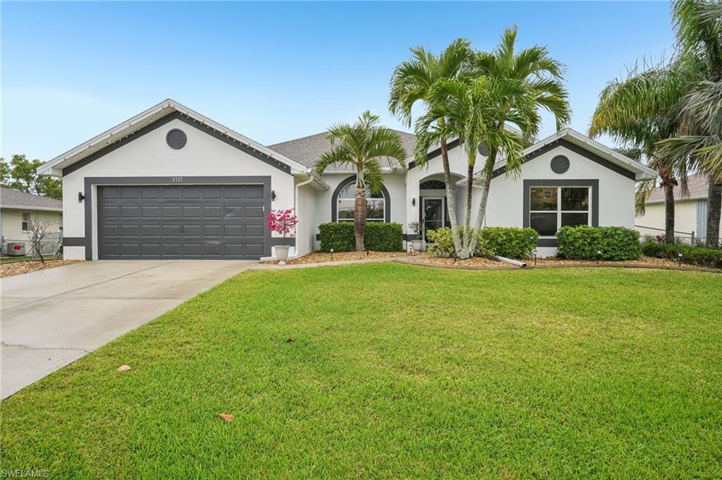 Spacious 4-bedroom, 2-bath pool home with over 2,300 square feet of living space in Southwest Cape Coral! This well-maintained home features vaulted ceilings, an open floor plan, tile flooring throughout, and a split-bedroom design. The kitchen offers granite countertops, solid wood cabinetry, stainless steel appliances, and plenty of counter space. The spacious primary suite features dual vanities, a soaking tub, and a separate walk-in shower. Step outside to enjoy the large screened lanai and solar-heated saltwater pool, complete with upgraded no-see-um screening. Recent improvements include a NEW ROOF (2022) with transferable warranty, impact-rated sliding glass doors, fresh interior and exterior paint, and epoxy garage flooring with overhead storage. CITY WATER AND SEWER, NO HOA, AND NO ASSESSMENTS! Additional savings with TRANSFERABLE FLOOD INSURANCE at approximately $1,200/year (subject to carrier approval). Conveniently located near Ida S. Baker High School, nearby elementary schools, shopping, dining, parks, and everything Southwest Florida has to offer. Currently tenant-occupied on a month-to-month basis at $3,250 per month, making this an excellent opportunity for a primary residence, seasonal getaway, or income-producing investment property. Schedule your private showing today!