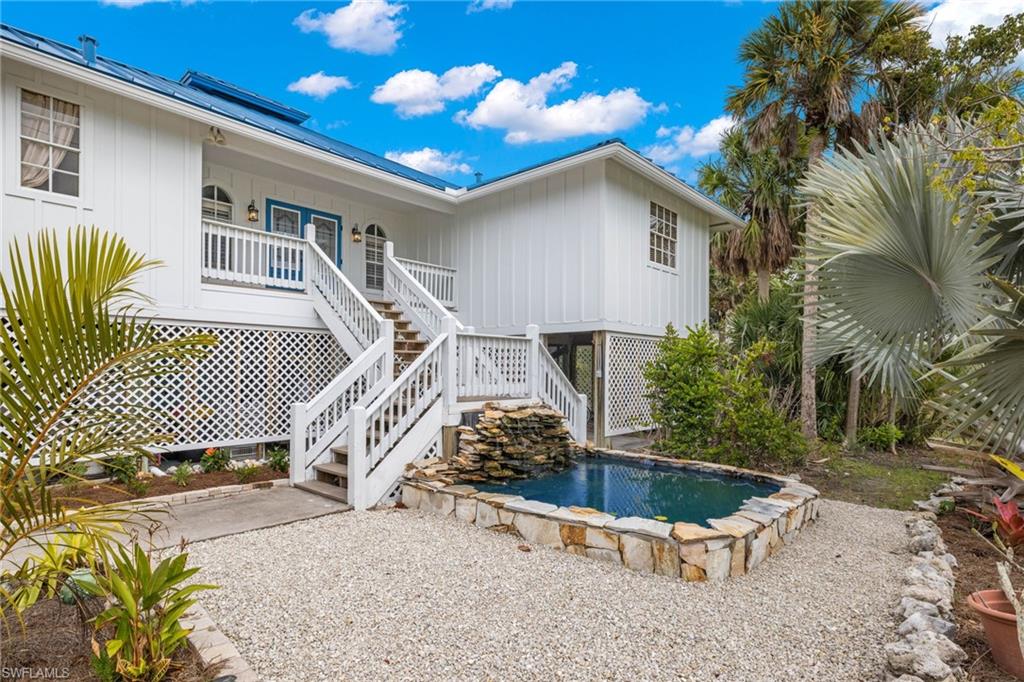 Experience the tranquility of island living in this spacious and private retreat. Boasting a welcoming open floor plan, this 3-bedroom, 2-bathroom home offers serene views of the pool and conservation land beyond. Inside, you'll find cathedral ceilings accentuating the airy ambiance, a modern kitchen featuring brand-new stainless-steel appliances, elegant crown molding, and recessed lighting. Enjoy the convenience of tile flooring throughout the living areas, while outside, the caged pool area boasts new equipment and a heater for year-round enjoyment. Step into the inviting A/C sunroom overlooking the conservation area, complete with impact windows for added peace of mind and extended living space. Recent updates include a new Standing Seam metal roof and Hardie board siding, ensuring both durability and style. Downstairs, discover ample storage space, including a storage room perfect for storing kayaks, bikes, and beach gear. Yard is great for plant lovers and owned by a couple who are considered one of the best private orchid growers in FL.  There are 3 pergolas with filtered automatic watering system.  There are 2 double level bonsai/cactus benches also on the programable watering system.