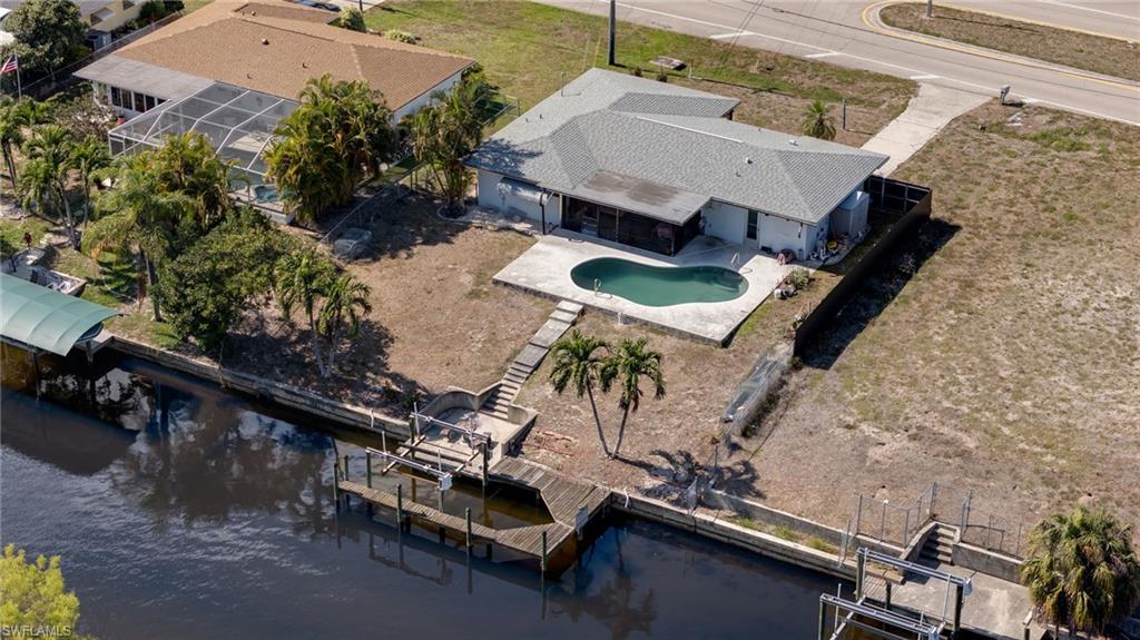 GULF-ACCESS, POOL HOME, LESS THAN 15 MINUTES TO OPEN WATER! NO FLOOD ZONE!!! If boating and fishing are part of your Florida lifestyle, 1522 Shelby Pkwy, Cape Coral, FL 33904 deserves your attention. Enjoy quick Gulf access with just one bridge offering approximately 11'3" of clearance, plus your own private dock and boat lift right in your backyard. Spend less time navigating canals and more time cruising, fishing, island hopping, or heading out for a sunset on the water. After a day on the boat, come home and relax by your south-facing private pool, offering plenty of Florida sunshine throughout the day. This beautifully maintained 3-bedroom, 2-bathroom waterfront home offers comfortable living space designed for both relaxation and entertainment. Step inside and you’ll immediately feel the warmth of a home that blends coastal charm with everyday functionality. The open living areas flow seamlessly, creating the perfect setting for family gatherings or hosting friends. Located in the highly desirable Cape Coral area, you’re close to dining, shopping, and everything Southwest Florida has to offer — yet tucked away in your own peaceful waterfront retreat. This isn’t just a home. It’s a lifestyle. Schedule your private showing today and start living the waterfront dream.