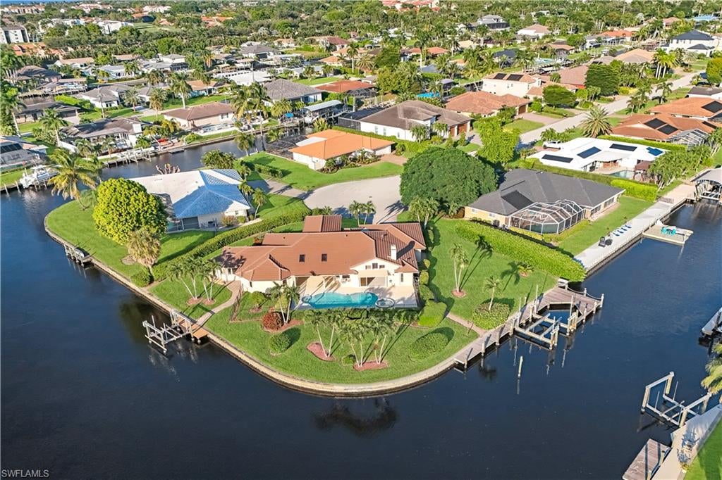 An extraordinary setting, exceptional boating access, and endless possibilities.  Rarely does a property offer such an exceptional combination of location, water frontage, and boating access. Perfectly positioned on a magnificent .43-acre corner lot in the highly desirable Town & River community, this remarkable property boasts an impressive 265 feet of water frontage, coveted southwestern exposure, and direct access to the open waters of Southwest Florida.

A true boater’s paradise, the property features two private boat docks and deepwater access capable of accommodating a yacht or large vessel. The larger lift can accommodate up to 40,000 pounds and a 50-foot boat, the smaller lift has a 7,500 pound capacity.  Whether enjoying a day cruising the Gulf waters, exploring the barrier islands, or simply taking in the spectacular waterfront views and breathtaking sunsets, this location offers an extraordinary waterfront lifestyle.

The existing three-bedroom, three-bath residence presents a wonderful opportunity for a discerning buyer to reimagine and transform the home to complement its exceptional setting. With its expansive lot, and water views the possibilities are inspiring. 954 Bal Isle Drive represents a rare opportunity to create a spectacular waterfront retreat in one of Fort Myers’ most established boating communities.