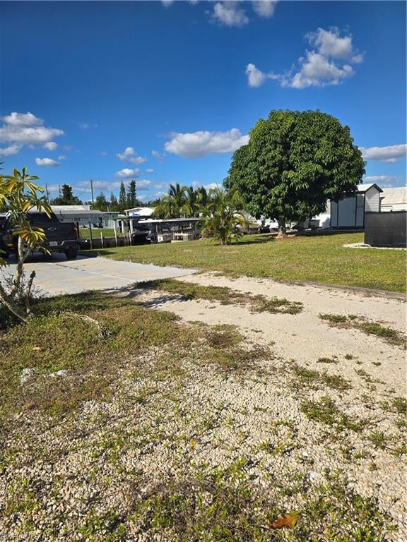 Experience the dream of living on a sub-tropical island teaming with wildlife and palm trees. This is a very nice property, only one back from the canal with a canal view. It previously had a home on it, so no full impact fee to replace it. Flamingo Bay has a voluntary HOA which provides access to their clubhouse, pool, tennis courts, boat launch plus more. Pine Island has so many wonderful faciities to offer, many churches,  marinas, several county parks, hiking trails, a bike path and many restaurants.  It also provides access to world class fishing,  with many local guides if you don't have your own boat. There are many events annually on the island such as the Mango Festival, Mullet Toss and others.   Pine Island also offers access to many Major League Baseball Spring Training parks within a reasonable drive. This property gives you the opportunity to experience the dream of owning a home in paradise. Welcome to "Island Time" where you can relax and enjoy all the beauty of nature and exceptional sunsets.