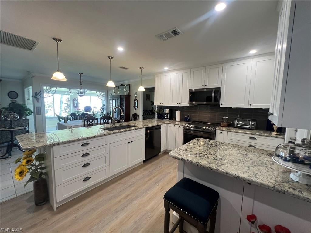 Welcome to your charming new home in Cape Coral, FL. Newly updated gourmet kitchen new appliances, huge open concept granite countertop, two bar stool areas, lots of new white shaker cabinets including ALL the modern upgrades a chef would choose. A wonderful spacious layout with three bedrooms and two bathrooms. Enjoy the open concept living area with abundant natural light, appropriate for entertaining. The BONUS back sunroom is surrounded with windows, letting the outside in, while keeping cool with AC. Primary Bedroom has a walk-in closet anyone would dream of having, on suite bath has been updated with modern new vanity w/granite countertop, beautiful, tiled tub/shower. Guest Bath has a nice walk-in shower. The well thought out backyard provides a cozy covered paved patio for outdoor relaxation, AND a pergola. The yard is fenced, with mature lovely landscaping, a serene oasis. Oversized 1+ car garage. Conveniently located near shopping, dining, and recreational opportunities, this property offers a wonderful living experience in a desirable community. Fully updated with new roof, and all wonderful updates in (2024) New plumbing in 2019. Call today for your personal showing.