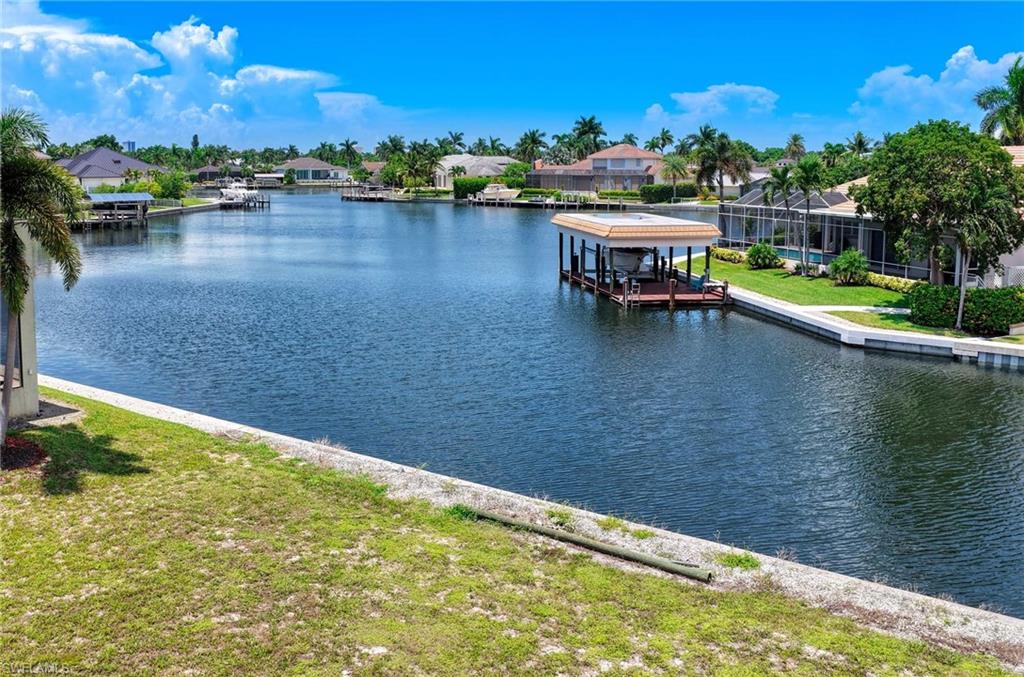 An Exceptional Waterfront Homesite on Marco Island. Set on a quiet cul-de-sac, this level waterfront lot offers approximately 100 feet of water frontage and generous 100' x 110' dimensions, providing an outstanding setting for a custom residence designed around the water. Enjoy a partial bay view and water-indirect boating with just one bridge at North Barfield Drive before reaching the Marco River and Gulf of Mexico. The established seawall and approximately .25-acre/10,890 SF homesite offer ample room to create a substantial new residence with pool, outdoor living and dockage. Surrounded by attractive waterfront properties in an established Marco Island neighborhood, 1674 Briarwood Court is an increasingly rare opportunity to secure a sizeable, flat waterfront lot and build exactly what you want in one of Florida's most desirable island communities.
