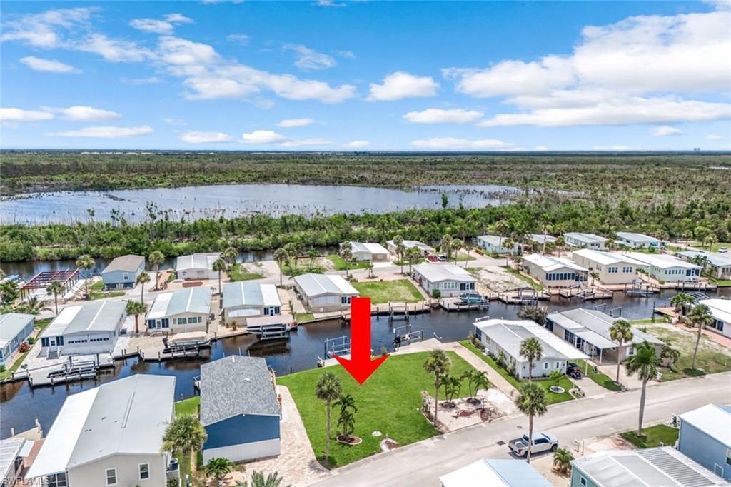 Imagine walking down to your own dock with your morning coffee and watching the sun come up over the canal. This east-facing waterfront homesite sits in Bayside Estates, a friendly 55+ community just off San Carlos Blvd. There are no bridges between you and the Gulf, so you can lower the boat off the 10,000 lb lift and head out to fish, catch the sunset, or spend the whole day on the water.

The groundwork is already done. Central water and sewer, underground electric, cable, and irrigation are at the lot, ready for the new manufactured home you design around the view.

Bayside Estates has pickleball and tennis courts, bocce, a community pool, and social events all year, so it's easy to get to know your neighbors. The $700 quarterly HOA covers lawn care, water, sewer, internet, street lights, street maintenance, and the rec facilities.

When you want a beach sunset, Fort Myers Beach and Margaritaville Resort are about 2.5 miles away.