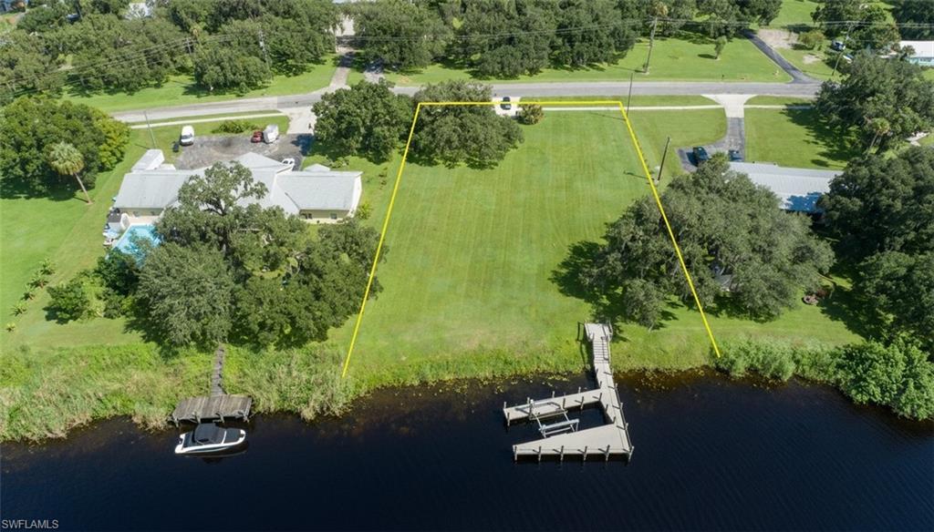 Rare Intracoastal Riverfront Homesite! This exceptional cleared waterfront lot is ready for your custom dream home and already features a driveway, underground electric, and a brand-new private dock with a boat lift and maintenance-free composite decking. Enjoy direct deep-water access to the Gulf, the Atlantic Ocean, and Lake Okeechobee via the Okeechobee Waterway.
One of the property’s most desirable features is that the homesite is outside the flood zone and is not subject to tidal fluctuations or storm surge, offering added peace of mind. Conveniently located just outside the LaBelle city limits, you’ll be within walking distance of the LaBelle Yacht Club for waterfront dining and Barron Park, where you can enjoy festivals, live entertainment, and community events throughout the year. This is a rare opportunity to own a premier waterfront homesite in one of Southwest Florida’s most desirable riverfront locations.