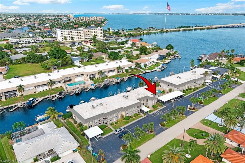 YOUR SOUTHWEST FLORIDA BOATING LIFESTYLE STARTS HERE! Welcome to River Gate Condos, nestled in Cape Coral’s desirable Yacht Club area and surrounded by million-dollar homes. This rare 1,625 sq. ft., 3-bedroom, 2-bath waterfront condo offers direct access to the Caloosahatchee River and out to the Gulf, plus your own private boat slip with a 10,000-lb. lift and composite dock just steps from your patio.

Enjoy an open-concept interior featuring luxury laminate and tile flooring, newer bedroom carpet, plantation shutters, granite countertops, stainless steel appliances and bar seating. A spacious Florida room adds extra living space and provides beautiful water views. The building also features a newer roof installed in 2023, adding another valuable update for the next owner.

Step outside to your own waterfront oasis, where boating, the community pool and the Southwest Florida lifestyle are right outside your door. Adding to the view, Cape Coral’s impressive new American flag can be seen from your own backyard, a striking sight along the waterfront and a unique backdrop to enjoy from home.

When you're ready to explore by land, Downtown Cape Coral is close enough to walk or bike to, with dining, entertainment and local events nearby. Whether you're searching for a full-time residence or your Florida getaway, bring your boat and start living the Southwest Florida lifestyle!