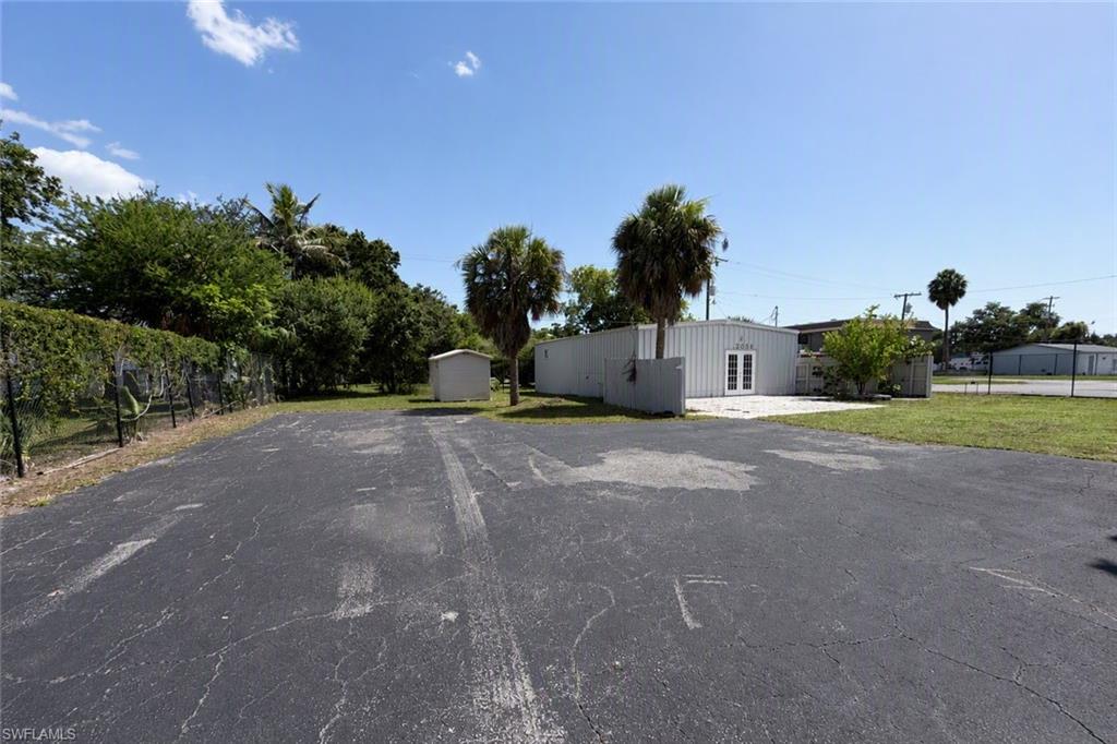 Monthly payment is $2300 including taxes and insurance per month.  This freestanding metal-frame commercial building sits on a fully fenced, gated .31-acre corner lot, offering controlled access via a rolling chain-link gate — an ideal setup for businesses that require added security or after-hours entry. The open-concept interior features high ceilings and a mix of recessed and fluorescent lighting, providing flexible space suited to retail, office, service, or studio use.

The building includes a kitchenette with cabinetry, a sink, and a full-size stainless-steel refrigerator, along with  one restroom featuring a tiled walk-in shower and updated vanity — a convenient amenity for staff or clients. French doors lead out to a paver patio and grassy side yard shaded by mature palms, creating a pleasant outdoor break area or secondary entrance point.  Please verify with city zoning the approved uses.