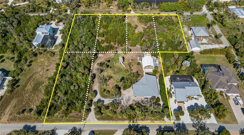 RARE COASTAL ACREAGE WITH UNRESTRICTED FLEXIBILITY, PRIVACY & EXCEPTIONAL FUTURE POTENTIAL

Opportunities to own nearly 3.2 acres so close to Sanibel Island, Fort Myers Beach, Bunche Beach and the Punta Rassa boat ramp are increasingly rare. This exceptional coastal property offers a unique combination of privacy, usable acreage, substantial climate-controlled storage and future development potential—all without HOA restrictions.

For the buyer seeking more than a traditional home, this property delivers remarkable freedom. Whether envisioned as a private coastal estate, home base for boats, RVs and collector vehicles, space for business or hobbies, or a strategic land acquisition, the scale and versatility create opportunities rarely available in this coastal location.

The 3-bedroom, 2-bath residence offers more than 2,100 square feet and features impact-glass windows, imported tile, beautiful hard pine flooring throughout the main living areas and Brazilian rosewood flooring in the primary bedroom. A generous climate-controlled lower level provides flexibility for storage, a workshop, studio, hobby space or other personalized uses.

A standout feature is the detached climate-controlled 32' x 35' building, featuring large access doors, a lift, power and water. It is ideal for vehicles, boats, equipment, tools, recreational toys or large-scale projects.

Outdoor living is equally impressive. An oversized lanai overlooks the expansive grounds, providing a peaceful private setting and the breathing room that only acreage can provide.

Perhaps the most compelling aspect is the future development potential. The approximately 3.2-acre parcel offers the potential to subdivide into up to seven buildable lots without retaining the existing residence, or potentially retain the home while creating five additional approximately half-acre lots. Buyers should independently verify all zoning, subdivision and development requirements with the appropriate authorities.

Located minutes from some of Southwest Florida's most desirable beaches, boating destinations and recreational amenities, this property offers a rare balance of coastal convenience and private acreage.

For the buyer who values space, freedom, flexibility and long-term potential, properties offering this combination of acreage, improvements, storage and coastal proximity are exceptionally rare. Whether your vision is a secluded coastal estate, personal base for your toys and hobbies, or strategic acquisition with future development possibilities, this property offers the canvas to make it a reality.

Opportunities of this scale and flexibility near Sanibel Island and Fort Myers Beach do not come along often. Schedule your private showing and experience the possibilities firsthand.
