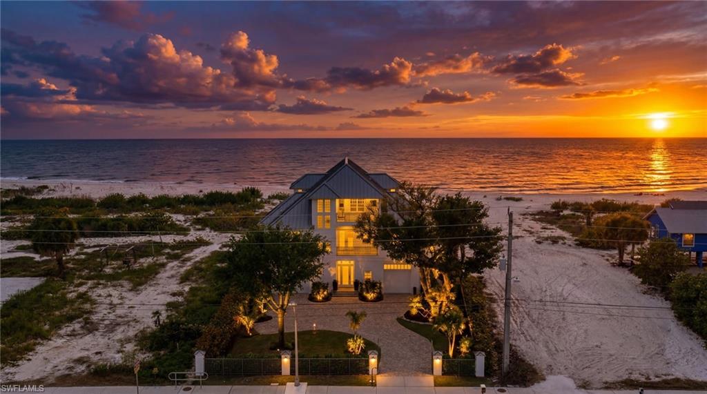 Set behind a gated entrance on an exceptionally large beachfront homesite, this sophisticated four-bedroom, four-and-a-half-bath Potter Homes estate presents a rare combination of privacy, scale, and direct Gulf access on the coveted south end of Fort Myers Beach.

The sense of arrival is remarkable. A sweeping front lawn, mature tropical landscaping, and lush natural surroundings create an estate-like setting seldom found along Estero Boulevard, providing both impressive curb appeal and a level of seclusion that feels worlds away from the traditional beachfront experience. Beyond the residence, private direct beach access places the Gulf just steps from your door.

Expertly constructed by Potter Homes, the residence blends timeless coastal architecture with gracious proportions and a thoughtful floor plan designed for sophisticated yet relaxed living. Expansive windows fill the interiors with natural light, while four bedrooms and four-and-a-half baths provide comfortable accommodations for family and guests. Multiple en-suite spaces allow everyone to enjoy privacy of their own.

Recent improvements include a new metal roof and a beautifully resurfaced lower-level pool deck. Surrounded by tropical landscaping, the private pool, jacuzzi, and generous outdoor living areas create an intimate resort setting ideal for entertaining, unwinding after a day on the water, or enjoying quiet evenings beneath the palms.

What truly distinguishes this property is the lifestyle its location affords. Enjoy the tranquility of a private beachfront retreat while remaining conveniently connected to the best of Southwest Florida. Santini Plaza’s dining and boutique offerings are nearby, while Bonita Springs and Naples place world-class restaurants, luxury shopping, championship golf, tennis, private clubs, boating, and entertainment within easy reach. Southwest Florida International Airport is also conveniently accessible.

Zoned for weekly rentals, the estate offers additional flexibility and income potential, making it equally compelling as a full-time residence, luxury second home, or investment property.

For the buyer seeking substantial beachfront land, a gated and beautifully landscaped setting, direct access to the sand, and effortless access to the Naples luxury lifestyle, this is an increasingly rare opportunity to own a true private coastal estate on Estero Boulevard.