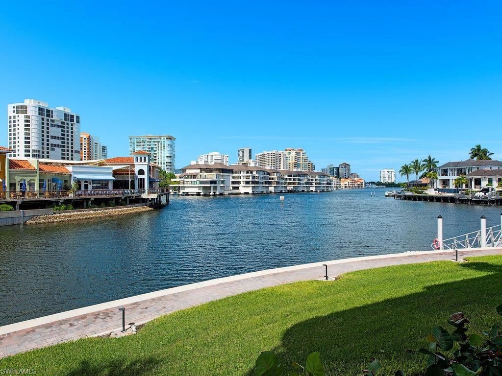 Enjoy breathtaking views of Venetian Bay from this beautifully maintained residence in Park Shore Landings. Spanning 1,753 square feet, this 2-bedroom plus den, 2-bath home offers an open-concept design that seamlessly connects the kitchen, dining, living, and lanai areas, creating an inviting setting for everyday living and effortless entertaining. The expansive west-facing lanai frames stunning sunsets and refreshing Gulf breezes, while abundant natural light enhances the warm and welcoming ambiance throughout. The primary suite is a serene retreat with a walk-in closet, dual sinks, and a walk-in shower. The kitchen features custom cabinetry, granite countertops, and a charming breakfast nook, striking the perfect balance of style and functionality. Additional highlights include impact-resistant windows, a comfortable den, a deeded covered parking space, and extra storage. Park Shore Landings offers exceptional amenities including a pool, spa, social room, library, and kayak storage and launch facilities. The community’s commitment to excellence is reflected in recent improvements, such as the 2022 reconstruction of the boardwalk, seawall, and 36 boat docks. Residents also enjoy access to a guest suite that may be reserved for visiting guests. Perfectly positioned just steps from Venetian Village and minutes from Waterside Shops, Artis-Naples, Mercato, and the renowned dining and shopping of 5th Avenue South and 3rd Street South, this residence provides an unmatched blend of coastal tranquility and vibrant urban convenience. Owners also have the exclusive opportunity to join the private Park Shore Beach, completing the quintessential Naples lifestyle.