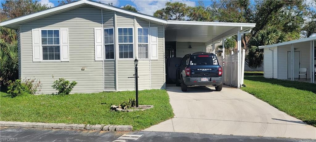 BRAND NEW ROOF on this 2008 Jacobson manufactured home which is located on one of the highest elevated lots in the Village with a private backyard! The home is beautifully furnished & sits on the outside edge of the community giving the home a secluded backyard retreat feeling. The open living room /dining room and kitchen has vaulted ceilings with upgraded 5-inch crown molding. The kitchen features an attached walk out screened lanai area that is elevated to the same height as the living level extending the kitchen to the outdoors enjoying every minute of the "Florida outdoor living lifestyle!" Upgraded Jacobson kitchen cabinets & stainless-steel appliances, good counter space & pantry, kitchen & baths have vinyl planking floors & solar tube lighting. This home boasts vaulted ceilings, drywall with 5-inch crown/ ceiling trim. The split plan features the master bedroom, master bath at one side of the home and on the opposite side of the home is the guest bedroom, guest bath & den. There are multiple uses for the DEN/ OFFICE/ EXERCISE ROOM or an additional sleeping area. This flexible room shows off with "Bay Windows" that stream in lots of natural light! The Master bath has a walk-in tiled shower. The guest bath has a tiled floor & linen cabinet. The washer & dryer is inside the home for convenience, newer A/C unit. Too many features to list. Spring Creek Village is an amenity rich community which boosts owned land plus low HOA fees because the Membership Certificate is included! Clubhouse, pool, spa, planned activities, social calendar, shuffleboard, tennis, pickleball, fresh water with lake with fishing pier and boat storage compound. Bay is 6 minutes from the community boat ramp, 15 minutes to the Gulf at Lovers Key & Doggie Beach, close to many waterfront restaurants, fishing, beaches, shelling, dolphins. Minutes from Coconut Point Mall, new Medical Facilities, Hertz Arena, Fort Myers Sports Complex, public golf courses, FGCU, and convenient to Ft. Myers International Airport & I -75