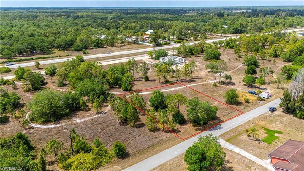 Great 1/2 Acre lot in the growing area of Lehigh Acres. Lightly wooded and a great place to build your dream home or hold onto for a future investment with paved road access.