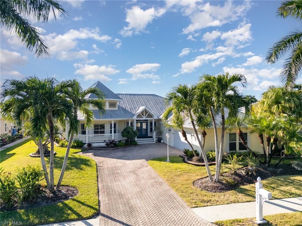 Old Florida Charm Meets Modern Comfort in Caloosa Creek- Tucked away on a lush half-acre lot in the exclusive, gated Caloosa Creek neighborhood, this meticulously maintained home embodies timeless Old Florida architectural charm. With 4 spacious bedrooms and 3 baths, and oversized 2.5 car garage, this residence offers a perfect blend of elegance, comfort, convenience and privacy. Step outside to your grand tropical oasis, where mango trees, birds of paradise, and lush landscaping create a serene backdrop. The expansive patio area features a sparkling pool and spa, ideal for relaxing or entertaining. An outdoor gas kitchen and a convenient pool bath make alfresco living effortless. The unparalelled Florida lifestyle! The chef’s kitchen is a true showstopper, featuring a Sub-Zero refrigerator, Wolf gas range, and an open layout that flows effortlessly into the great room. Entertaining is a delight, with the interior living space seamlessly connecting to the lanai and expansive outdoor area. Located just minutes from the beaches of Sanibel and Fort Myers Beach, as well as top restaurants, shopping, and entertainment, this home captures the very best of Southwest Florida living.