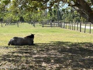 This horseperson's dream property is a perfect getaway in paradise on Pine Island, close to fishing, boat ramps, and restaurants and bars.  2.56+ or - acres with stellar improvements.  Property has well water, city water, and electric.  There is a large gravel pad for RV's with hook ups, two shipping containers, (45 ft and 20 ft) with electric and lights for feed, hay, tack, and equipment storage.  Two pole barns, one with two 10 x 10 stalls and one with two 12 x 12 stalls and custom swing gates.  Both pole barns are elevated and matted.  Property is fenced with no climb and electro braid top line to keep critters out and horses in.  16 ft entry gates, newer well pump, and the east fence line was replaced in 2025.  Quiet and peaceful on a dead end road, safe and functional.  Very well maintained.  This property is located on the highest elevation on the island and did not flood during the past 3 storms.  Zoning is AG-2 and a single family residence is allowed.