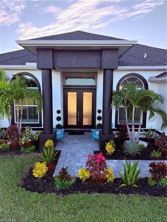 NEW CONSTRUCTION, GULF ACCESS, NO FLOOD INSURANCE FEMA APPROVED, 9.0 feet elevation, WITH BOAT LIFT/DOCK & HOME IS FULLY FURNISHED! Escape to your private waterfront oasis in highly desirable NW Cape Coral perfectly blending ultimate luxury with absolute peace of mind. Waterfront tranquility with custom side dock setup optimized for effortless boat parking, privacy, and 100 foot canal water views. (Location, Location, Location). This custom-built 2347 sq ft, modern masterpiece features 4 bedrooms, additional family room (including a flexible separate office/4th bedroom), 3 luxurious baths, and an expansive open floor plan bathed in abundant natural light through high-end architectural designed style windows. Every detail exudes sophistication, from the 24”x24” marble-style porcelain tile flooring to the soaring 10-foot structural beam construction accented with elegant tray ceilings and crown molding throughout. The interior showcases an Impressive primary bathroom suite unlike any other, complete with two separate showers, a soothing rain shower, and an elegant Roman tub! The chef-inspired kitchen is a showstopper, boasting an impressively large layout, premium stainless-steel appliances, staggered lighted wood cabinets with crown molding, and an upscale Level Four leathered granite Fourteen foot long Waterfall Island. 8-foot doors everywhere and a dramatic 14-foot octagon tray ceiling highlighted by custom ambient rope lighting. Nearby, the oversized garage features a ten-foot ceiling and an extra three feet of length - providing ample room for large vehicles, marine gear, and storage. Step outside to your ultimate exterior Florida Living Sanctuary. The expansive lanai with the boat dock off to the side, features premium picture-window screening to offer unobstructed, breathtaking 100-foot canal views, perfect for serene mornings and unforgettable evenings without any bugs. Relax in your luxurious, saltwater pool and integrated jacuzzi (heated by your smartphone App), or walk down the paver steps to your private side positioned dock. Boaters will Love the 10,000-lb boat lift and remote lighted canopy, providing an effortless cruise to the open Gulf! Built to the highest modern standards, this home is fully armored, with Low-E, PGT Hurricane-Impact Geometric Shape Accent windows and doors - including five massive 8-foot sliding glass doors and front privacy-glass "rain shower" impact entry doors which provide daylight AND privacy at the same time! High-end upgrades include custom plantation wood shutters on all windows and custom rolling linen shades on all sliders for Peaceful seclusion. Rich, lush, landscape, Turn-key ready and professionally styled with brand-new, elegant coastal contemporary furniture, and whole-house water reverse-osmosis system, this magnificent home is truly one of the grandest waterfront opportunities on the market today. Don't just imagine paradise. Come live the dream!