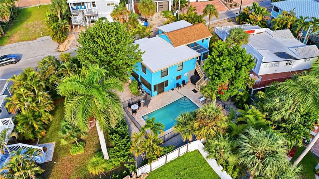 STRONG INVESTMENT OPPORTUNITY! PROVEN VACATION RENTAL WITH EXCEPTIONAL UPSIDE POTENTIAL! This charming ELEVATED coastal cottage sits on a RARE OVERSIZED 1.5-SIZE LOT and offers the perfect combination of established rental income, personal enjoyment, and future development potential. Located in the highly desirable WEEKLY RENTAL ZONE of Fort Myers Beach, this property boasts a proven history of year-round rental demand, strong REPEAT BOOKINGS, and consistent income production, even with minimal marketing.

FRESHLY PAINTED AND READY TO ENJOY! Continue operating as a vacation rental with projected GROSS INCOME POTENTIAL of approximately $100,000 annually, or take advantage of the oversized lot to BUILD A NEW 5-BEDROOM LUXURY VACATION RENTAL with projected GROSS INCOME POTENTIAL exceeding $200,000 annually!

The existing home features an OVERSIZED POOL, spacious sun deck, and generous low-maintenance backyard, creating a private tropical retreat ideal for entertaining, relaxing, and enjoying the Florida lifestyle. The lower-level bedroom and full bathroom provide additional flexible space for guests, storage, or future reconfiguration.

Whether you're seeking an income-producing investment, a personal beach getaway that helps pay for itself, or an opportunity to develop a high-performing luxury vacation rental, this property offers tremendous versatility and long-term potential. ENJOY IT WHEN YOU WANT, RENT IT WHEN YOU'RE AWAY! Contact the listing agent for rental history, income projections, and development pro forma.

One or more photo(s) has been virtually staged, AI generated, or rendered.