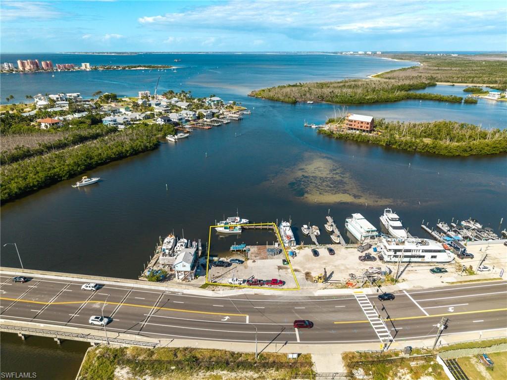 BUY NOW BEFORE FORT MYERS BEACH IS FULLY REBUILT! RARE WATERFRONT COMMERCIAL MARINA OPPORTUNITY WITH DIRECT GULF ACCESS, OWNED SUBMERGED LAND & EXISTING DOCK!

This is your opportunity to invest in the future of Fort Myers Beach while waterfront commercial property with this much potential is still available. Located directly on San Carlos Boulevard, approximately one mile from downtown Fort Myers Beach, this bayfront commercial property offers visibility, traffic exposure, deep-water boating access, existing dock infrastructure, and OWNED SUBMERGED LAND — a combination that is increasingly difficult to find in Southwest Florida.

Fort Myers Beach continues to rebuild, redevelop, and evolve. As new hotels, restaurants, attractions, marinas, and businesses return to the area, waterfront commercial sites with direct boating access may become even more limited. Secure your position now before the surrounding area is fully transformed.

Situated on Pelican Bay, the property offers fast, deep-water access toward the Gulf with minimal idle time, making it especially attractive for marine and tourism-related businesses. A large existing dock is already in place, opening the door to a wide range of potential uses including a marina, fishing charter operation, boat rentals, tiki tours, dolphin tours, sunset cruises, water taxi service, eco-tourism, marine services, or other waterfront business concepts.

The property is surrounded by businesses and attractions that already draw boaters, vacationers, and local residents, including fishing charters, waterfront restaurants, boat tours, rentals, and other marine-based operations. For anyone looking to establish or expand a Fort Myers Beach boating or tourism business, this location puts you directly in the middle of one of Southwest Florida’s most active waterfront corridors.

The OWNED SUBMERGED LAND is one of the most important features, offering long-term control and flexibility that is extremely rare with waterfront commercial real estate.

Whether you are searching for Fort Myers Beach commercial real estate, Southwest Florida marina property, waterfront commercial land, Gulf-access investment property, marine business location, or bayfront redevelopment opportunity, this property offers a combination of location, water access, infrastructure, and future potential that is difficult to duplicate.

INVEST NOW IN THE FUTURE OF FORT MYERS BEACH. As redevelopment continues, opportunities like this may become increasingly difficult to find. Secure your waterfront position today and build toward what this area is becoming.