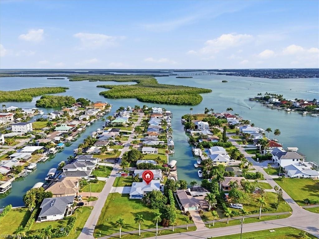 This is a rare opportunity to acquire a direct Gulf-access triplex ideally positioned at the end of a quiet canal in the highly desirable Isles of Capri. Set on an oversized lot with effortless boating access and just a five-minute cruise to the open Gulf, this fully renovated waterfront asset represents a compelling blend of lifestyle appeal and income potential. Each of the three one-bedroom, one-bath residences has been thoughtfully upgraded to today’s luxury standards, featuring granite countertops, stainless steel appliances, soft-close custom cabinetry, modern tile flooring, and elegantly redesigned bathrooms with walk-in tiled showers and granite vanities. Two of the units open seamlessly to a tranquil canal-front lanai, creating a private waterfront setting ideal for morning coffee or sunset entertaining. Designed with both owner convenience and rental performance in mind, the property offers private entrances, in-unit laundry in two residences, and a shared laundry facility in the garage—making it exceptionally well-suited for short- or long-term rental strategies. Recent capital improvements include a new metal roof, brand-new driveway, newer HVAC systems, new water heaters, and freshly painted interiors, ensuring a truly turnkey, low-maintenance investment. Located just minutes from downtown Naples and Marco Island, this prime waterfront location is in high demand for vacation rentals and Airbnb, offering strong revenue potential and long-term appreciation. Whether you’re an investor seeking to maximize cash flow or a buyer looking for a flexible coastal retreat with income upside, this exceptional triplex delivers on location, luxury, and performance. Waterfront investments of this caliber are increasingly rare. Secure your opportunity to own a direct Gulf-access property with enduring value and endless possibilities.