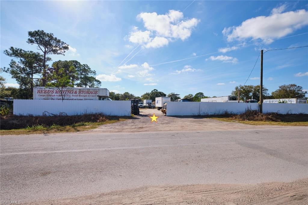 Prime 1.04± Acre Heavy Industrial Lot With Full Fencing, Utilities, and Dual 20x30 RV Carports

Unlock functionality and visibility with this improved Heavy Industrial parcel located on Industrial Loop in the rapidly growing LaBelle market. Zoned I-2 Heavy Industrial, this 1.04± acre property is ideal for manufacturing, logistics, equipment storage, contractor operations, or other commercial uses requiring ample space and robust infrastructure.

Featuring almost 200 feet of paved road frontage and over 200 feet of depth, the lot offers plenty of room for more buildings, office space, vehicle flow, or any future expansion. The property is fully fenced for security and equipped with electric and water already onsite, providing immediate operational capability. Two oversized 20x30 RV-style carports with enclosed rear sides offer covered parking for large vehicles, machinery, or materials—perfect for businesses needing protected storage.

Located just outside LaBelle city limits, the property benefits from proximity to local amenities without city taxes. Neighboring active industrial and commercial businesses, the lot sits only steps from LaBelle Airport, within walking distance of Highway 29, and just minutes from Highway 80—offering excellent regional connectivity.

LaBelle continues to experience significant growth, making this a strategic time to invest in industrial real estate. This central Southwest Florida location puts you roughly 20 miles from Fort Myers, 1.5 hours to Florida’s east coast, 2 hours to Miami, and about 2.5 hours to Orlando and Tampa.

A rare opportunity to secure a fully equipped, high-visibility industrial site in one of Southwest Florida’s fastest-growing markets—ready for immediate use!