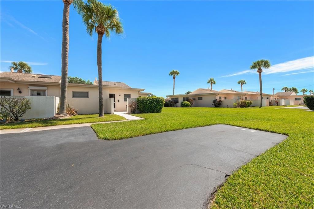 WATERFRONT - END UNIT - two-bedroom, two-bath condo in the inviting 55+ community of Beach Club Colony. Larger floorplan - 970 sq ft with Huge Florida Room.  City water and sewer. The pool and picnic area are near the unit. Enjoy water views from your enclosed lanai, or stroll along the Lake Camille canal and witness the abundance of fish and wading birdes.  The community is active with amenities like shuffleboard courts and a private pool, perfect for socializing and relaxation. Laundry, lawn service, pool service, common Lighting and Building Insurance are all part of the Association fees. AE flood zone - seller states the unit has not flooded during the recent storms.  Located on Joel Blvd, you'll benefit from convenient access to gas stations, restaurants, grocery stores, and other essential services. Additionally, enjoy easy commutes to State Road 80 and the heart of Lehigh Acres. Beach Club Colony offers a lifestyle of comfort, community, and convenience.  Seller would consider partial owner financing with satisfactory offer.