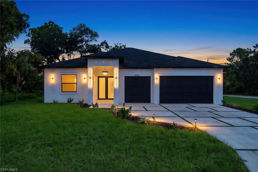 Welcome to this beautifully crafted new construction corner-lot home offering 4 bedrooms, 3 bathrooms, and 2,121 square feet of thoughtfully designed living space. The open-concept layout is enhanced by soaring 10-foot ceilings, tray ceilings in the living room, foyer, and primary suite, and abundant natural light that creates a bright, inviting atmosphere throughout.

The modern kitchen is designed to impress, featuring quartz countertops, a waterfall island, sleek flat-panel cabinetry, a tile backsplash, stainless steel appliances, a range hood, and convenient USB-C charging ports built into the island. The spacious primary suite offers a walk-in closet and a spa-inspired bathroom complete with floating dual vanities, glass shower doors, and a luxurious multi-head walk-in shower. Two additional full bathrooms, including a guest bathroom with a tub and another with a walk-in shower, provide comfort and flexibility for family and guests.

Designed to embrace the Florida lifestyle, the covered lanai features an outdoor kitchen, creating the perfect space for entertaining or relaxing year-round. Additional highlights include tile flooring throughout, impact-resistant windows and doors, modern interior doors, LED lighting, decorative soffit lighting, ceiling fans in every bedroom and on the lanai, metal exterior doors, and quality finishes throughout. Situated on a desirable corner lot, this home offers added space, enhanced curb appeal, and modern design with the comfort and functionality today's buyers are looking for.