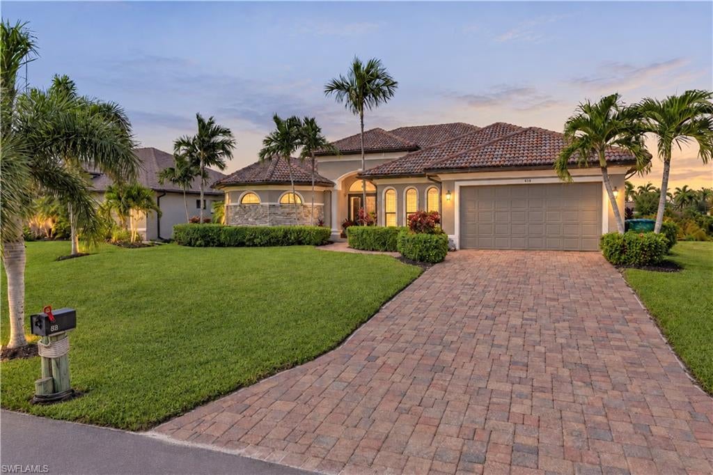 EXPERIENCE EXCEPTIONAL WATERFRONT LIVING—WHERE SOPHISTICATION, COMFORT, AND BREATHTAKING SUNSETS SET THE STAGE FOR SOMETHING EXTRAORDINARY! Discover this stunning Gulf-access residence at 828 NW 39th Ave, Cape Coral, offering 2,721 square feet of beautifully designed living space and an impressive combination of refined interiors and spectacular outdoor amenities. From the moment you enter, an inviting atmosphere welcomes you with spacious living areas designed for both relaxation and entertaining. Spectacular zero-corner sliding glass doors create a seamless transition between indoor and outdoor living, filling the home with natural light and showcasing captivating views of the pool and canal. A KITCHEN DESIGNED TO IMPRESS! Elegant granite countertops, a generous center island, stainless steel appliances, and a convenient coffee/wine bar create an exceptional culinary space ideal for casual dining or hosting memorable gatherings. The adjoining dining area overlooks the outdoor retreat, offering a beautiful backdrop for every occasion. THE OUTDOOR EXPERIENCE IS NOTHING SHORT OF SPECTACULAR! An expansive screened lanai reveals a heated saltwater pool, relaxing spa, fully equipped outdoor kitchen, and comfortable seating areas designed for year-round enjoyment. Desirable western exposure provides the perfect setting to take in Florida's magnificent sunsets while entertaining guests or unwinding after a long day. A BOATER'S DREAM AWAITS! Situated along a Gulf-access canal, this exceptional property features a private wooden dock and a 10,000-pound boat lift, offering convenient access to Southwest Florida's remarkable waterways. Spend your mornings enjoying tranquil canal views, afternoons exploring by boat, and evenings relaxing along the waterfront. Inside, the primary suite provides a peaceful retreat with an ensuite bathroom featuring dual sinks, a soaking tub, and a separate shower. Additional bedrooms and bathrooms offer comfortable accommodations for family and guests, while a versatile den, currently used as a home office, provides flexibility for remote work or personal interests. A dedicated laundry room with utility tub and an air-conditioned garage equipped with a mini-split system add practicality and convenience. AN EXCEPTIONAL HOME FOR THOSE WHO APPRECIATE THE FINER SIDE OF FLORIDA LIVING! Combining impressive interior spaces, outstanding outdoor entertainment amenities, and Gulf-access boating opportunities, this remarkable residence offers an extraordinary setting for creating lasting memories. YOUR NEXT CHAPTER BEGINS HERE—SCHEDULE YOUR PRIVATE SHOWING AND EXPERIENCE THE DIFFERENCE!