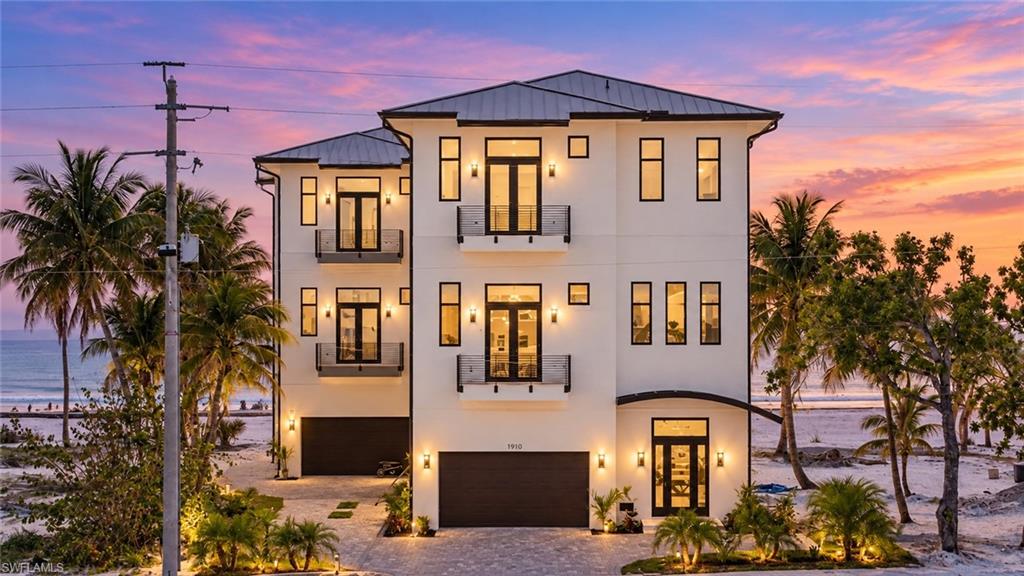 One or more photo(s) has been virtually staged, AI generated or rendered.  Panoramic Gulf and sand views define this elevated Gulf-front residence, completed in 2022 and offering over 3,000 square feet of modern coastal design. Positioned on the sand side of Estero Boulevard, the home delivers direct beachfront living with a private dune walkover placing the shoreline just steps away. Elevated on concrete pilings and constructed to current standards, this 4-bedroom, 4 +1/2-bath property combines architectural presence, durability, and refined finishes. The interior is characterized by clean lines and volume, featuring 14-foot ceilings, porcelain tile flooring, flush baseboards, and expansive floor-to-ceiling glass sliders that capture sweeping Gulf views throughout the main living spaces. European-style interior doors and high-gloss cabinetry establish a sleek, cohesive aesthetic, complemented by custom LED lighting features inside and out that enhance both form and function. The chef’s kitchen is thoughtfully designed for entertaining and everyday use, anchored by a striking waterfall island, abundant cabinetry, and the opportunity for a full feature wall with a custom range hood and floating shelving. The open-concept layout allows seamless flow between kitchen, dining, and living areas while maintaining a strong visual connection to the Gulf. All bedrooms are configured as en-suite retreats, each featuring floating vanities, zero-edge showers, and frameless glass enclosures, reinforcing the home’s modern design language. The primary suite offers private balcony access, Gulf views, and a spa-inspired bath. A private elevator services all levels, including the main living level where a rare elevated pool and integrated spa are positioned—providing a unique vantage point for relaxing or entertaining while enjoying Gulf and sky views. This elevated design enhances usability and maintains a strong connection between indoor and outdoor living. Located mid-island, the property offers immediate beach access while remaining close to essential amenities, dining, and the revitalized Fort Myers Beach town center. Its elevated construction, contemporary architecture, and Gulf-front location make it well-suited as a primary residence, luxury second home, or income-producing beachfront rental. 3050 Estero Boulevard presents a rare opportunity to own a modern, elevated Gulf-front home with direct beach access and refined coastal design in one of Fort Myers Beach’s most desirable locations.